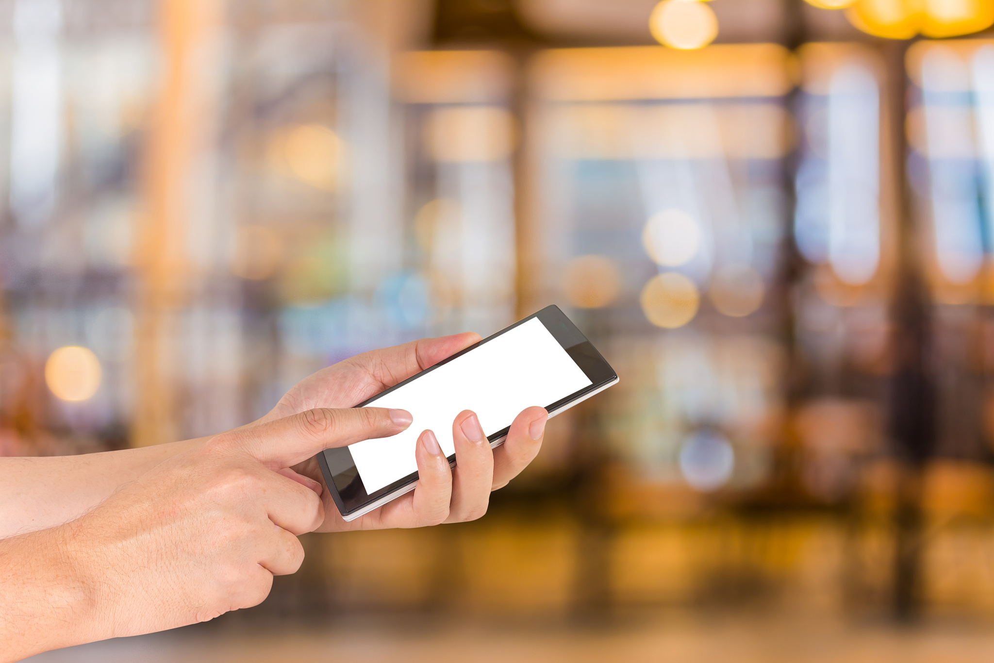 modern touch screen phone and coffee shop