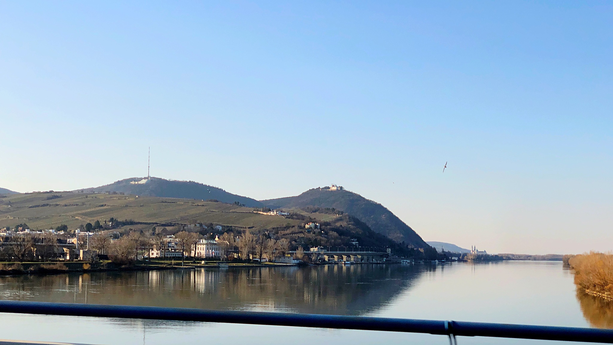 scenic view of lake by mountains against clear sky