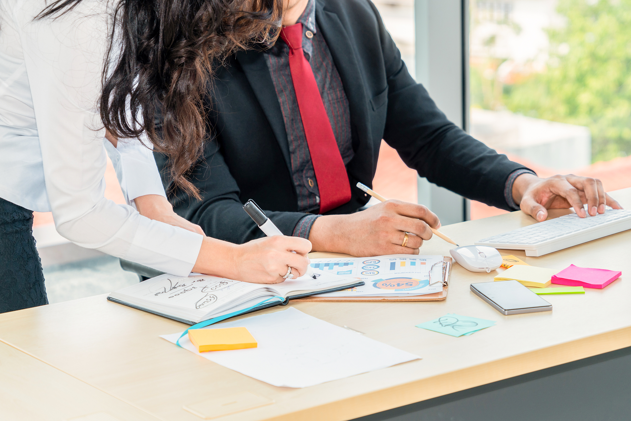 two business people talk project strategy at office