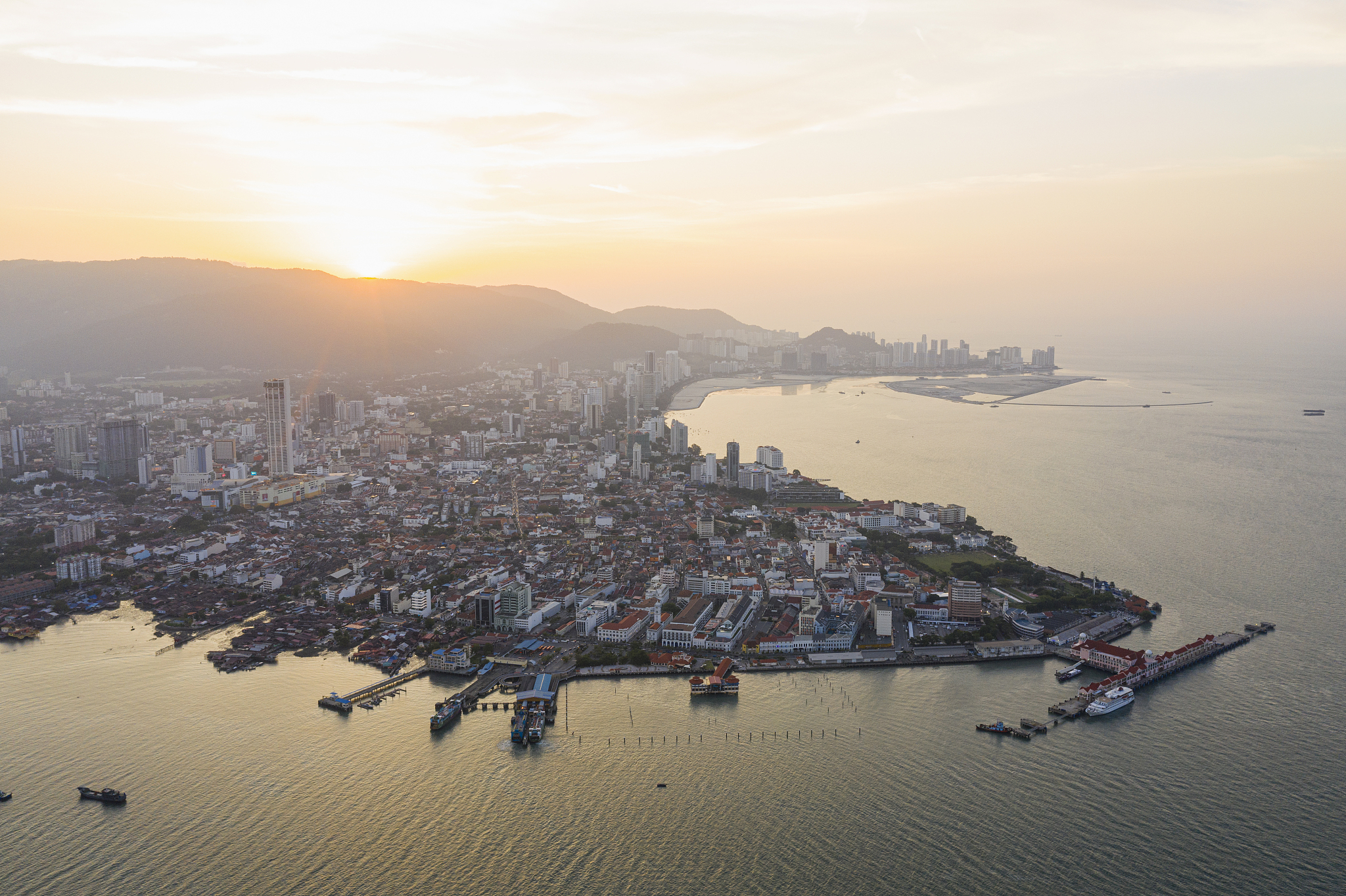high angle view of buildings in city during sunset