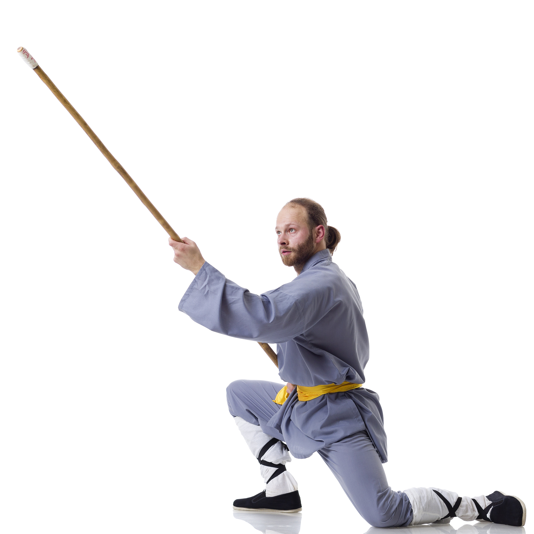 kung fu fighting position with wushu cudgel isolated on white