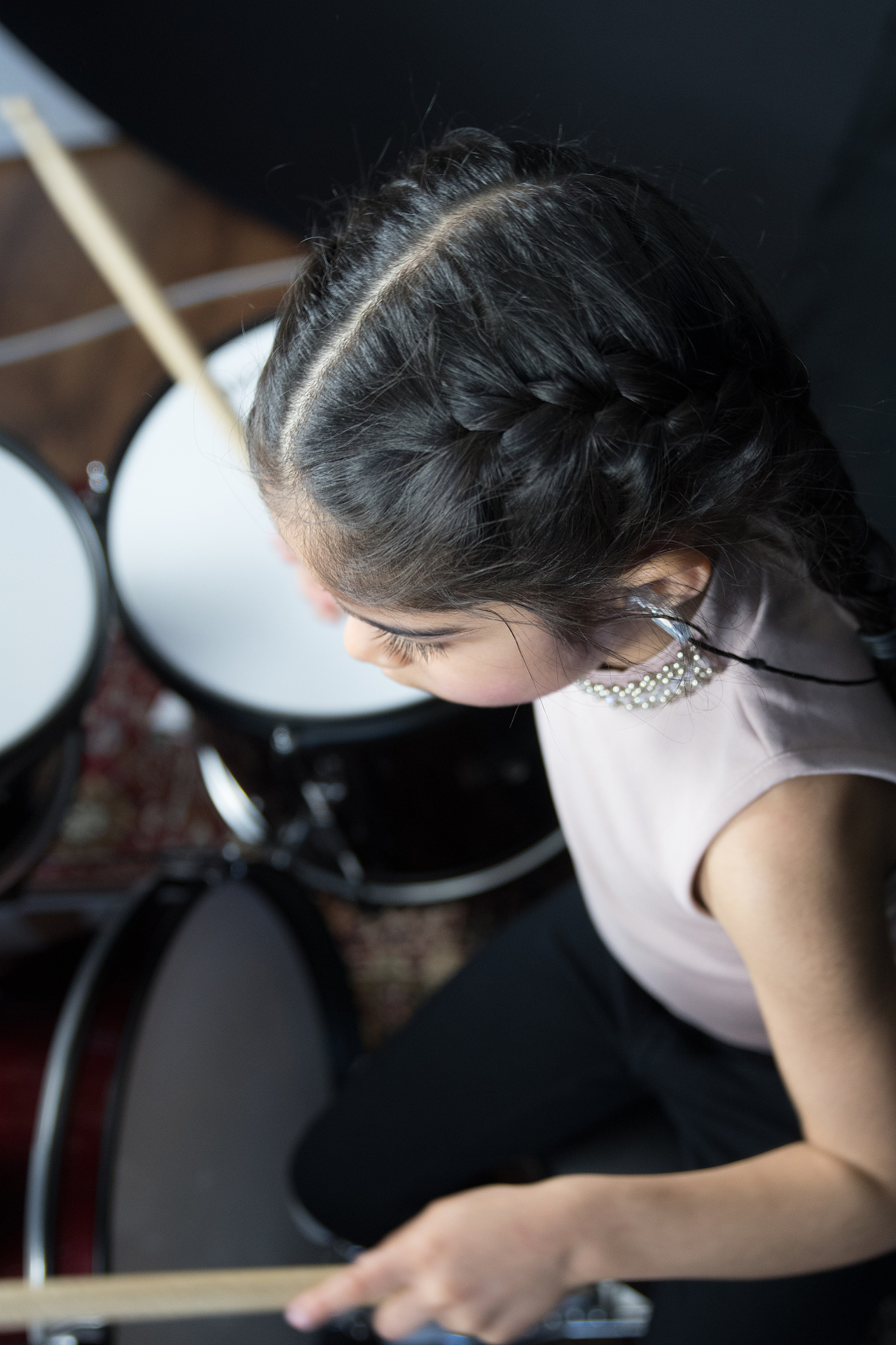 5 year old girl practices the drums