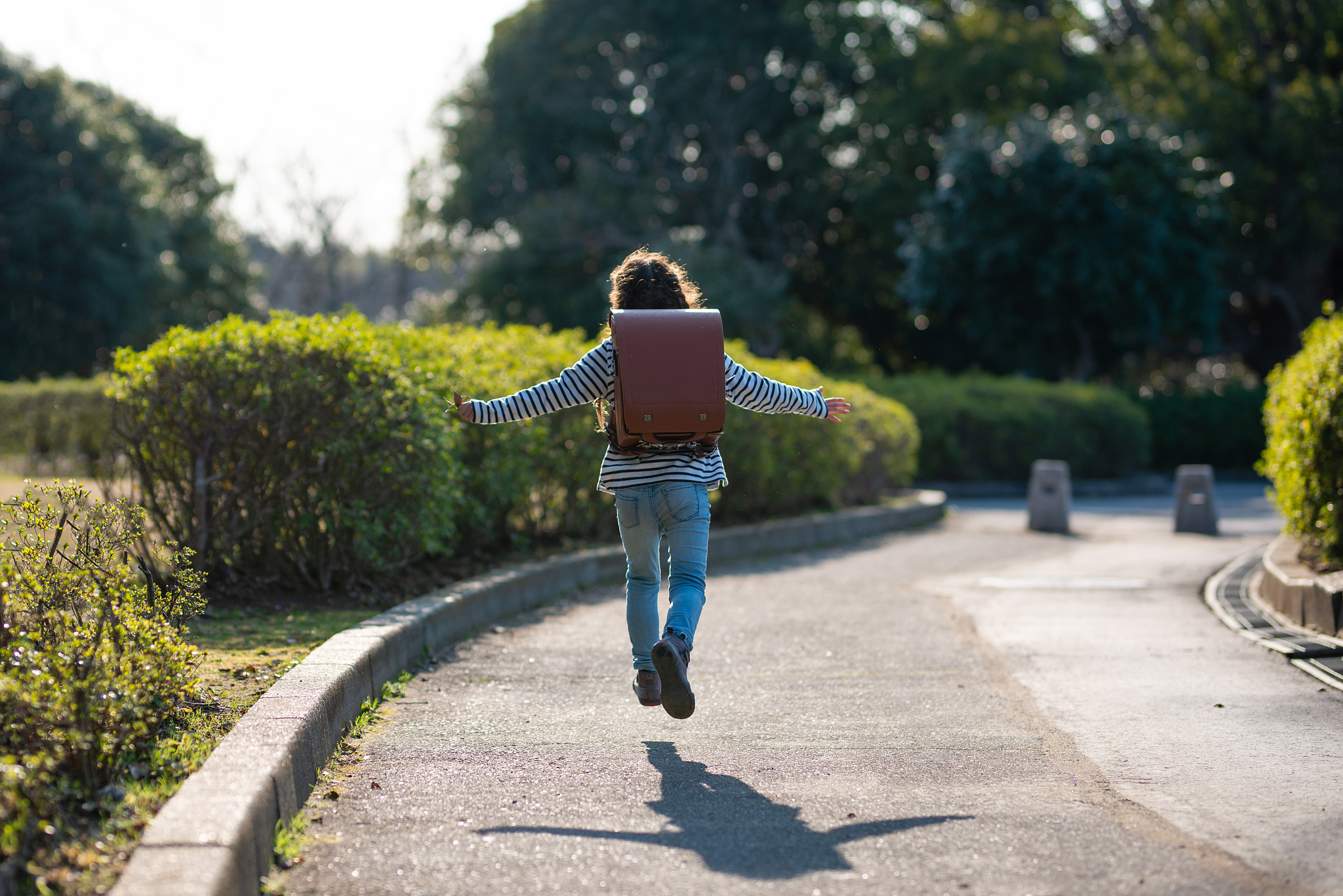 girl carrying a school bag