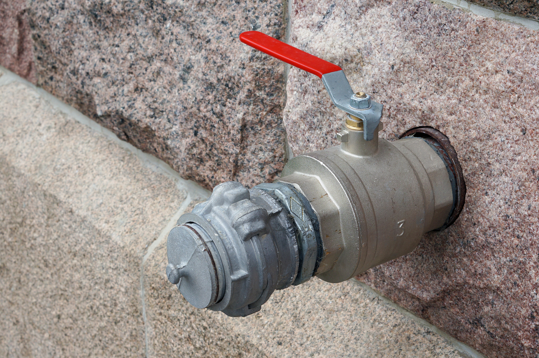 fire hydrant and water tap  reeled into a granite wall
