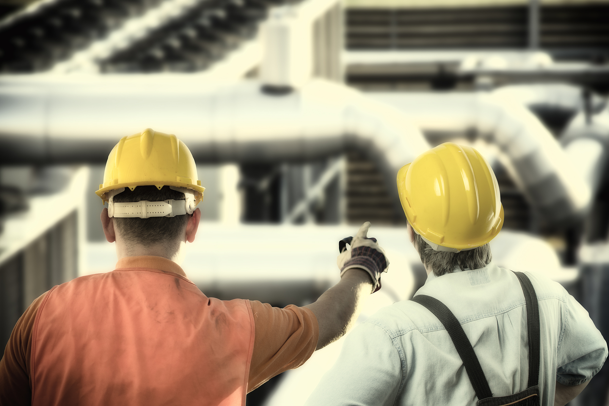 worker in protective uniform and protective helmet