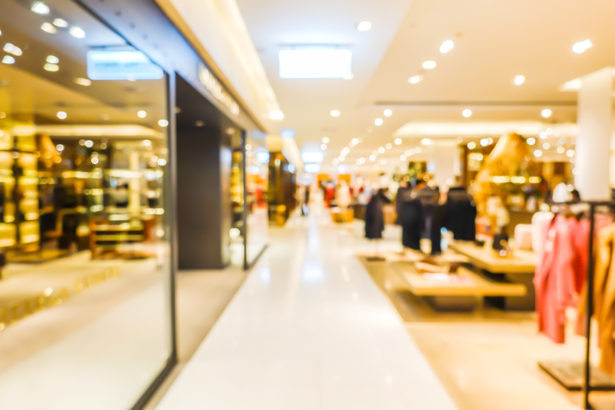 blurred of big shopping mall has many products. beautiful clothe