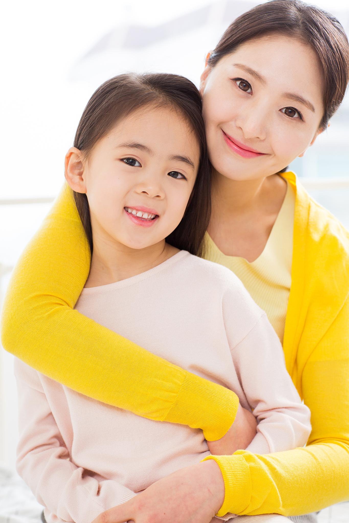 mother hugging her daughter