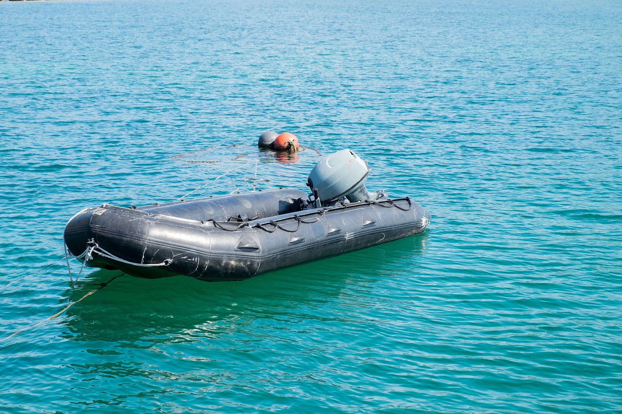 rubber boat floating nearby the pier