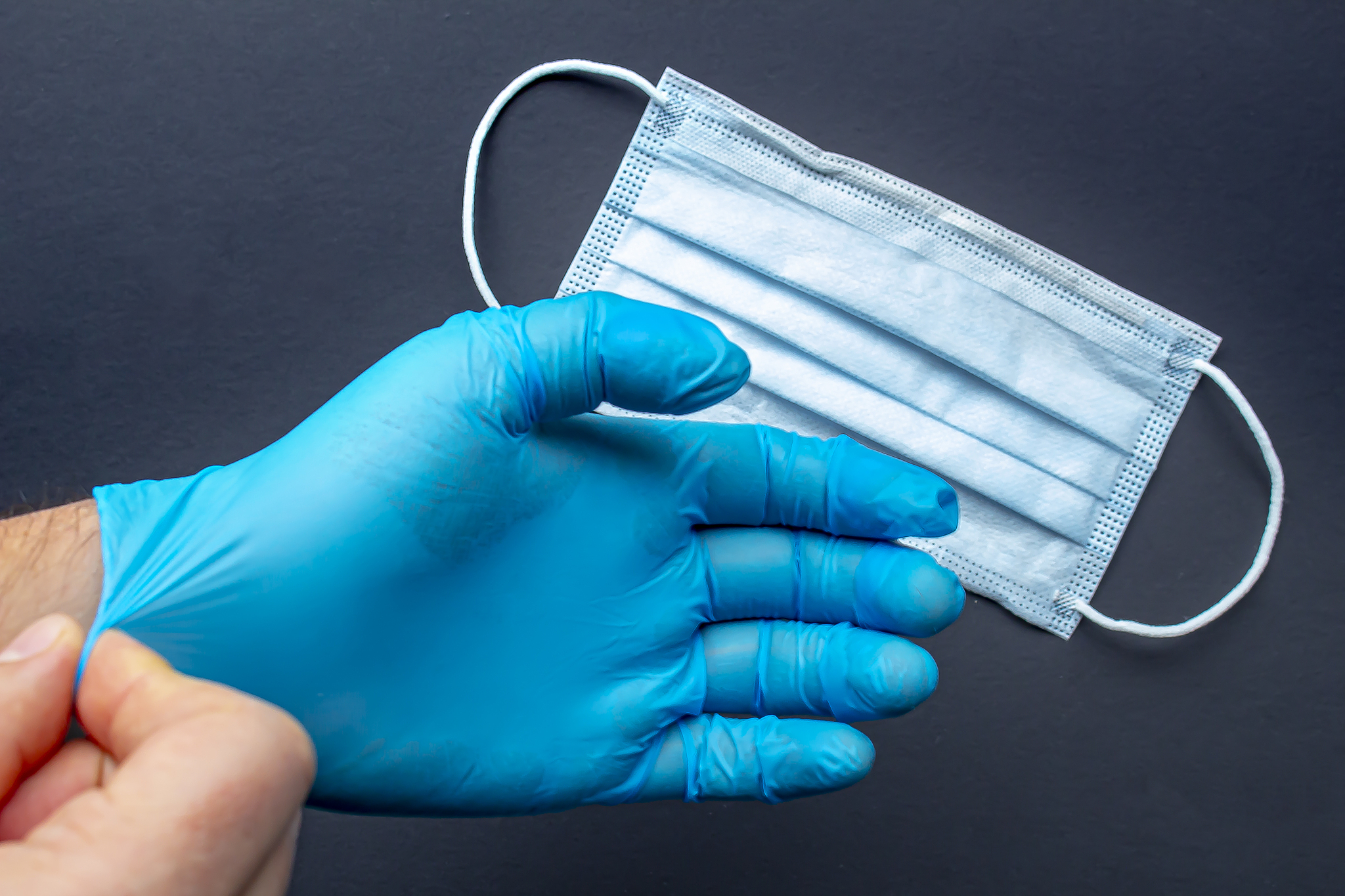 a medical first responder wearing gloves and face mask