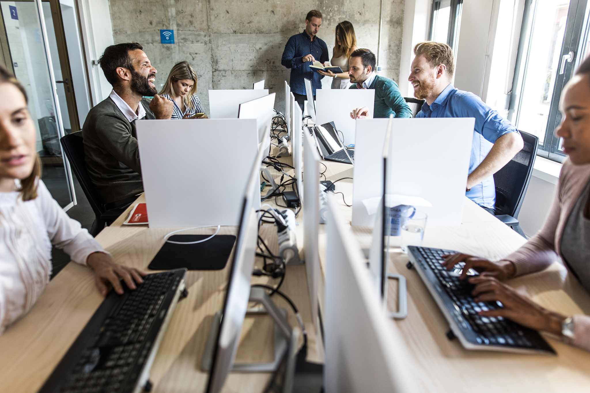 computer programmers talking while working in a software company
