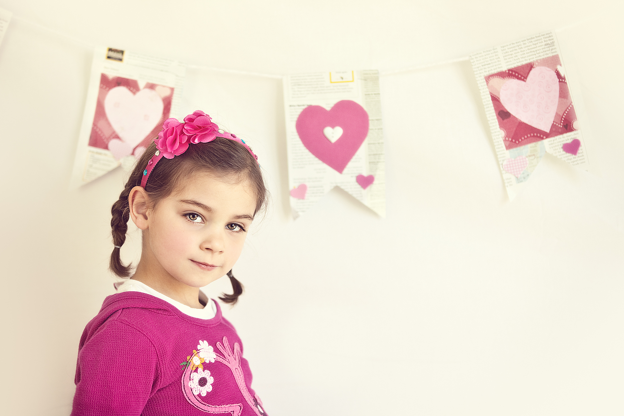 cute little standing in front of heart banner