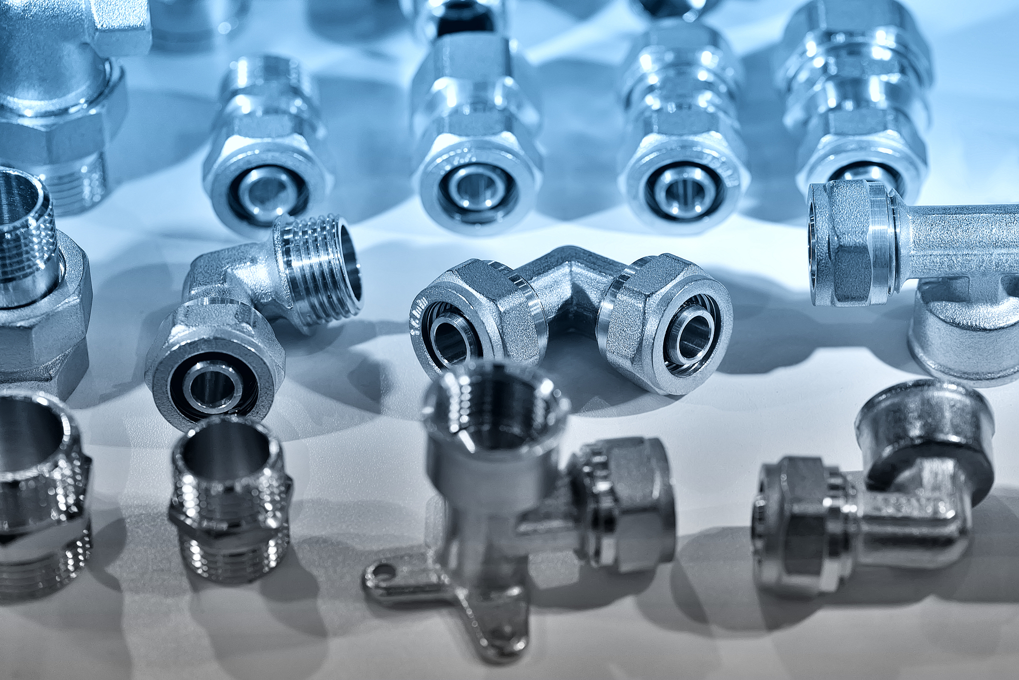 a variety of plumbing pipe connectors, corners, adapters. blue t