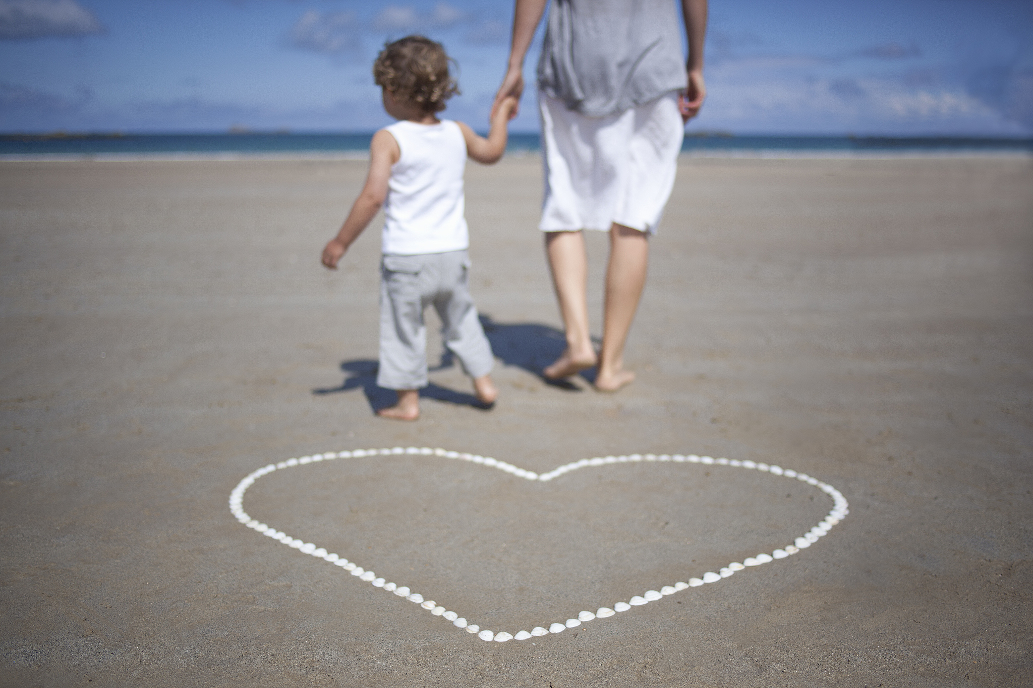 woman and son in front on the beach