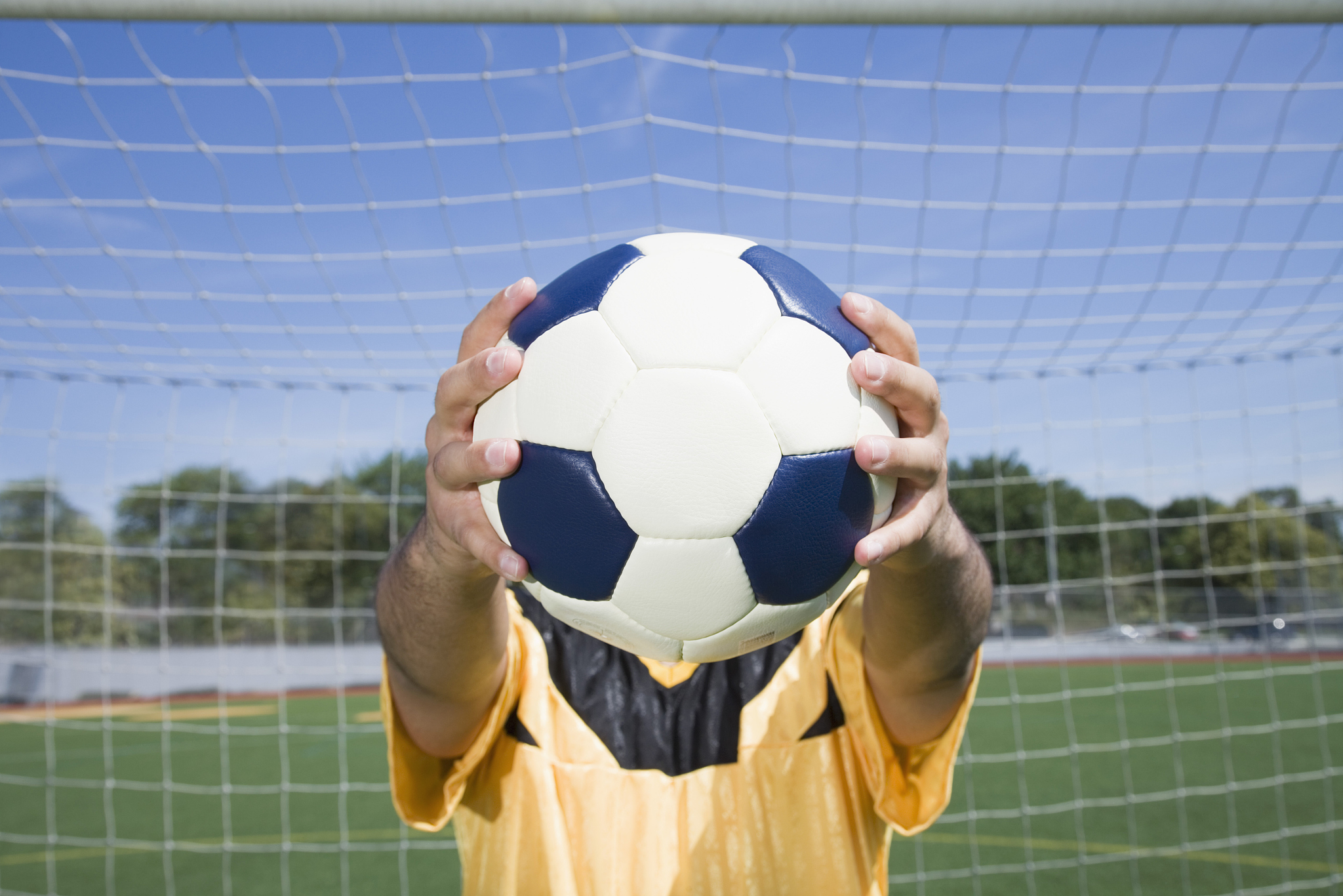 soccer player holding ball