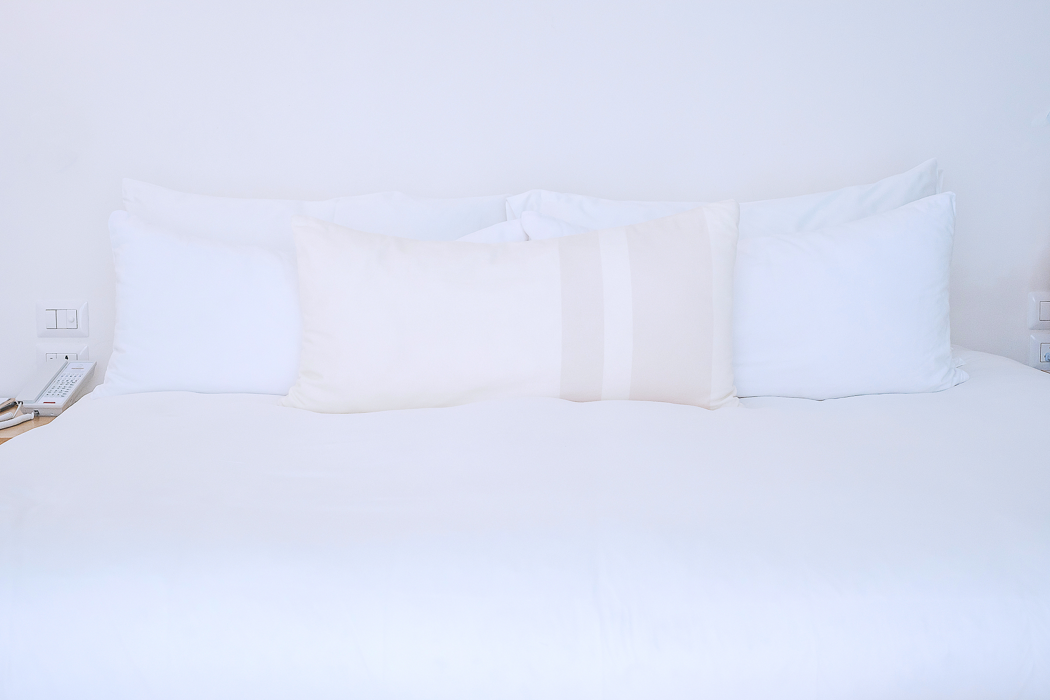 clean pillows on bed in luxury hotel room or modern home. sleepi