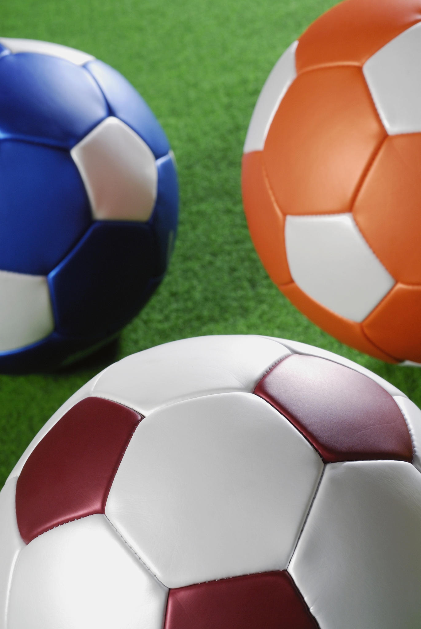 close-up of three soccer balls