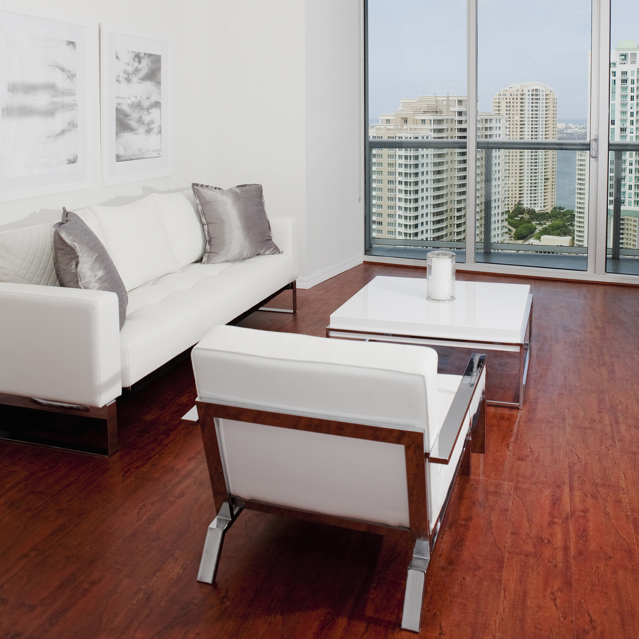 sofas, coffee table and window overlooking high rise buildings i