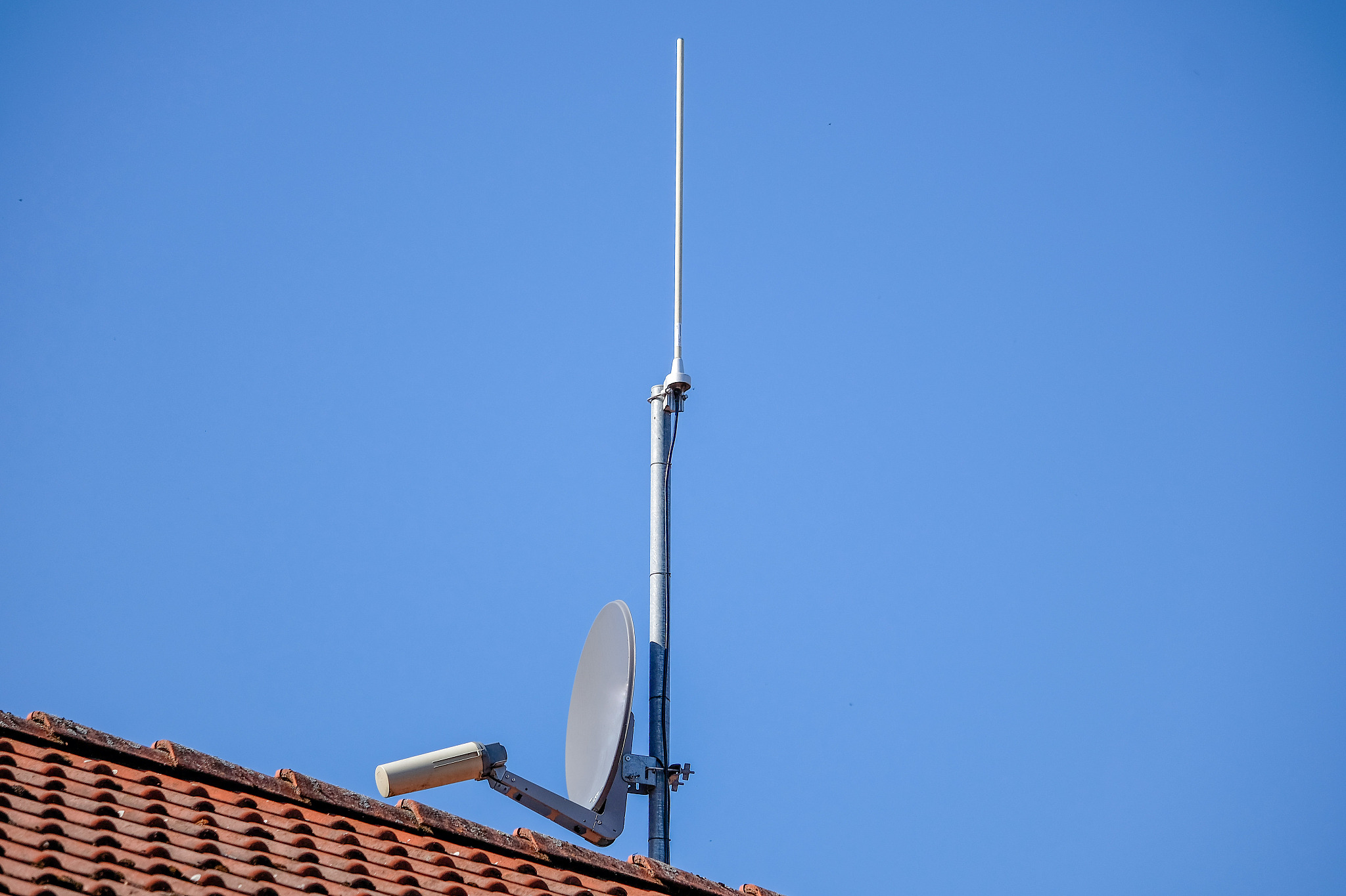 old satellite dish on a house wall