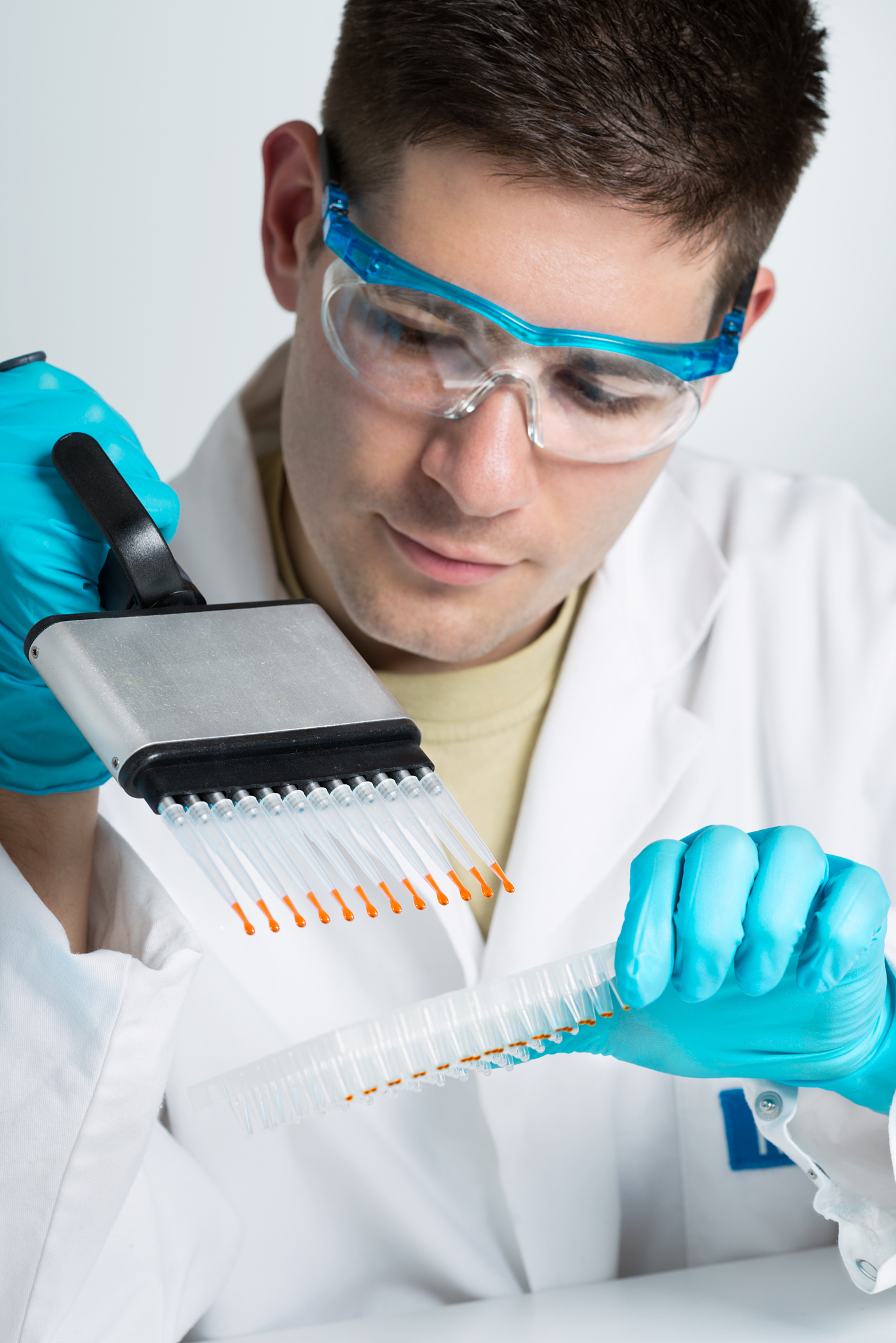 young biologist with multichannel pipette