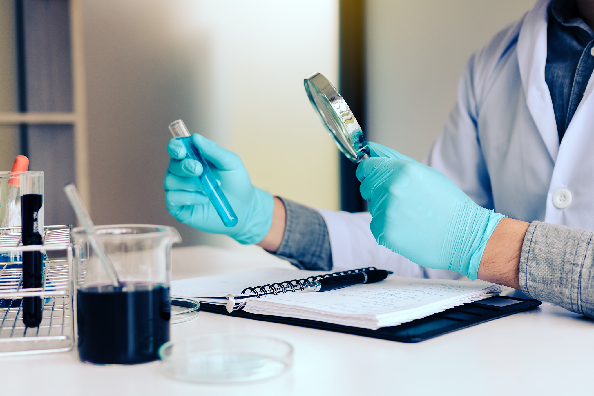 chemist or scientist using magnifying glass dispense the solutio