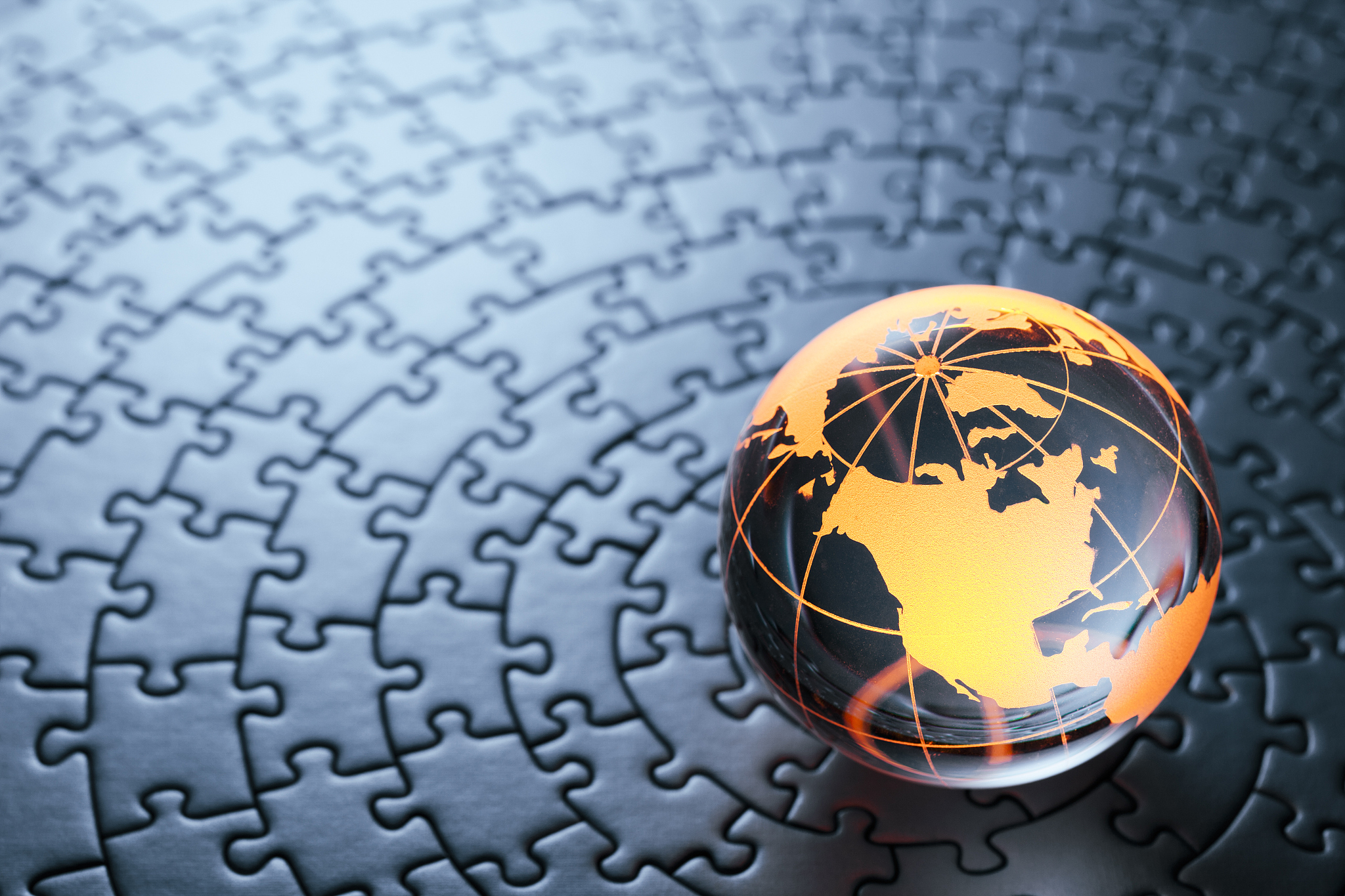 glass globe on circular jigsaw puzzle