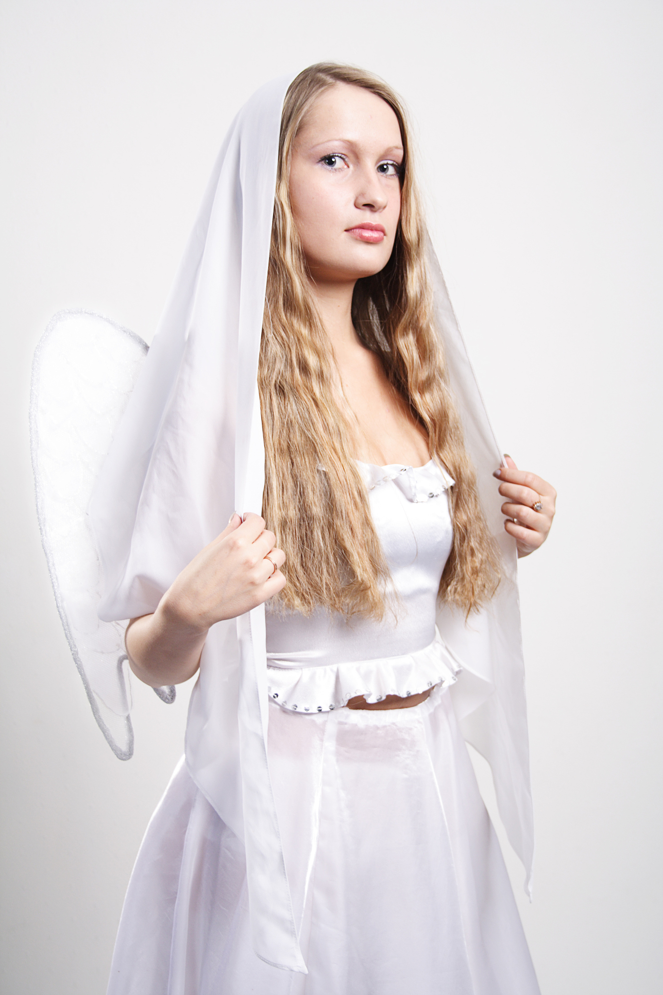 Cinematic Angel with Dark Hair, White Dress & Golden Jewels