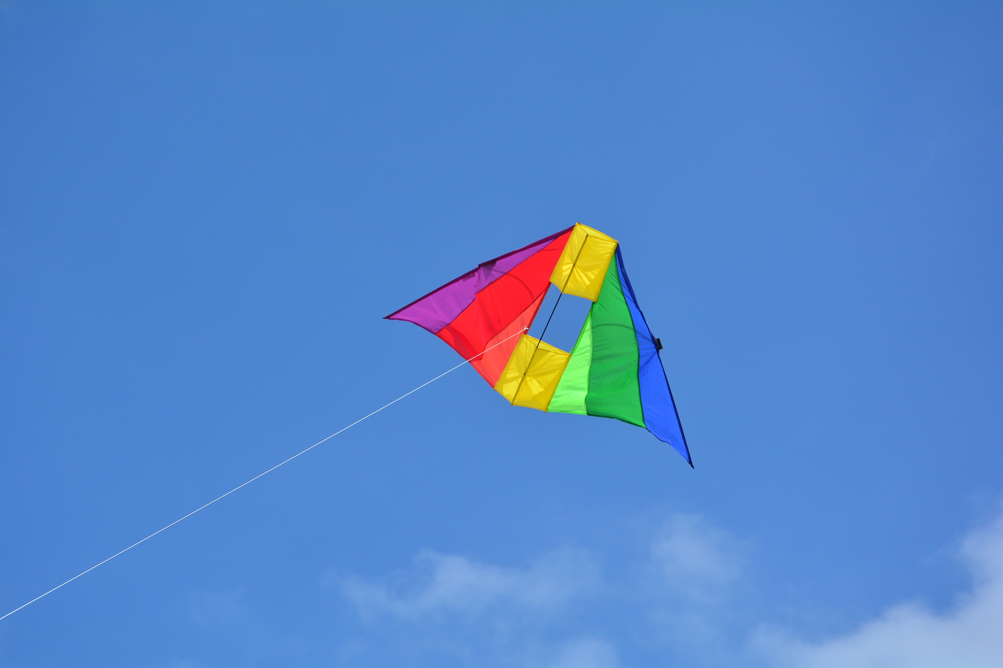 low angle view of kite flying against blue sky with many copy sp