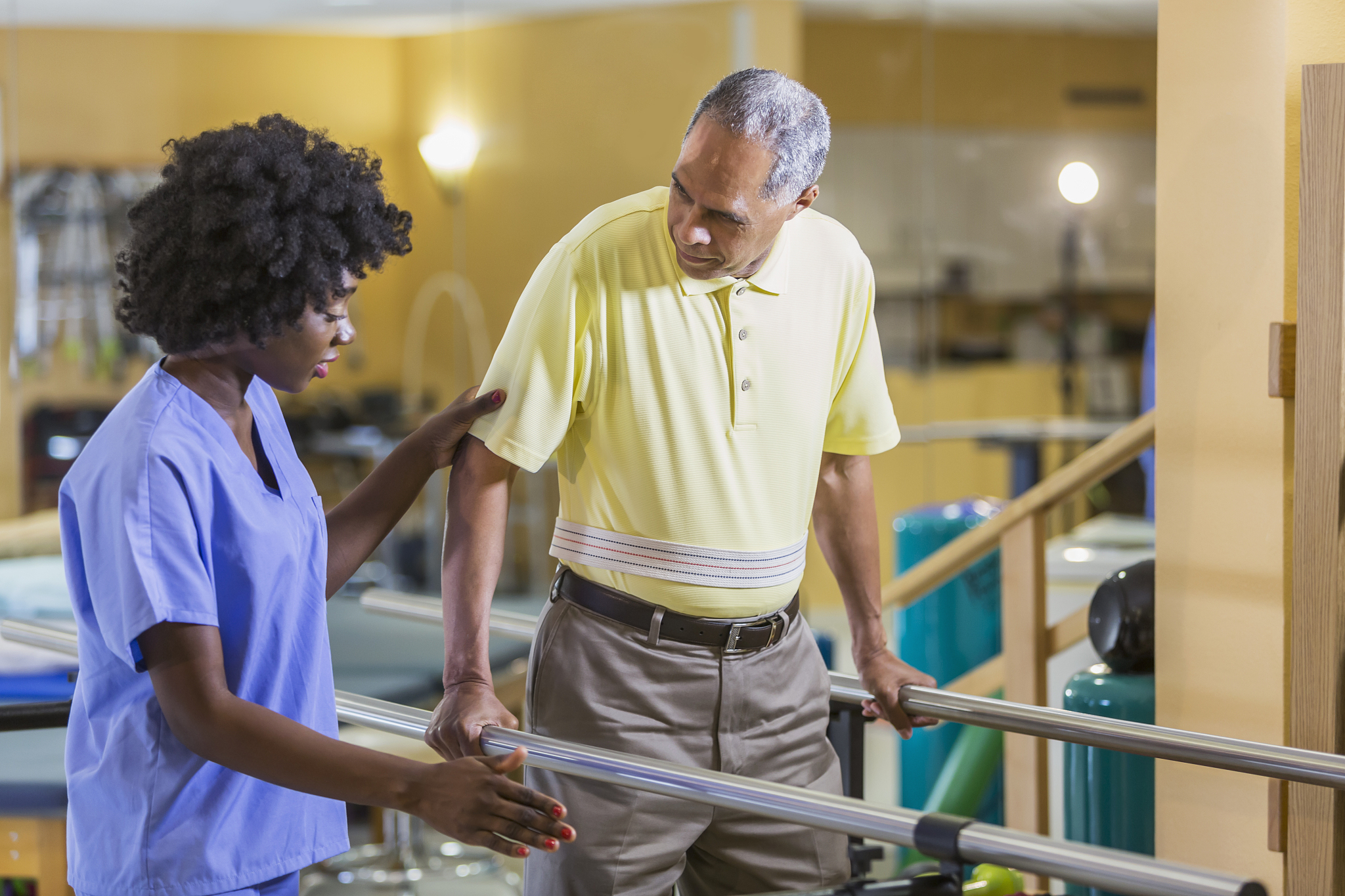 female physical therapist working with male patient