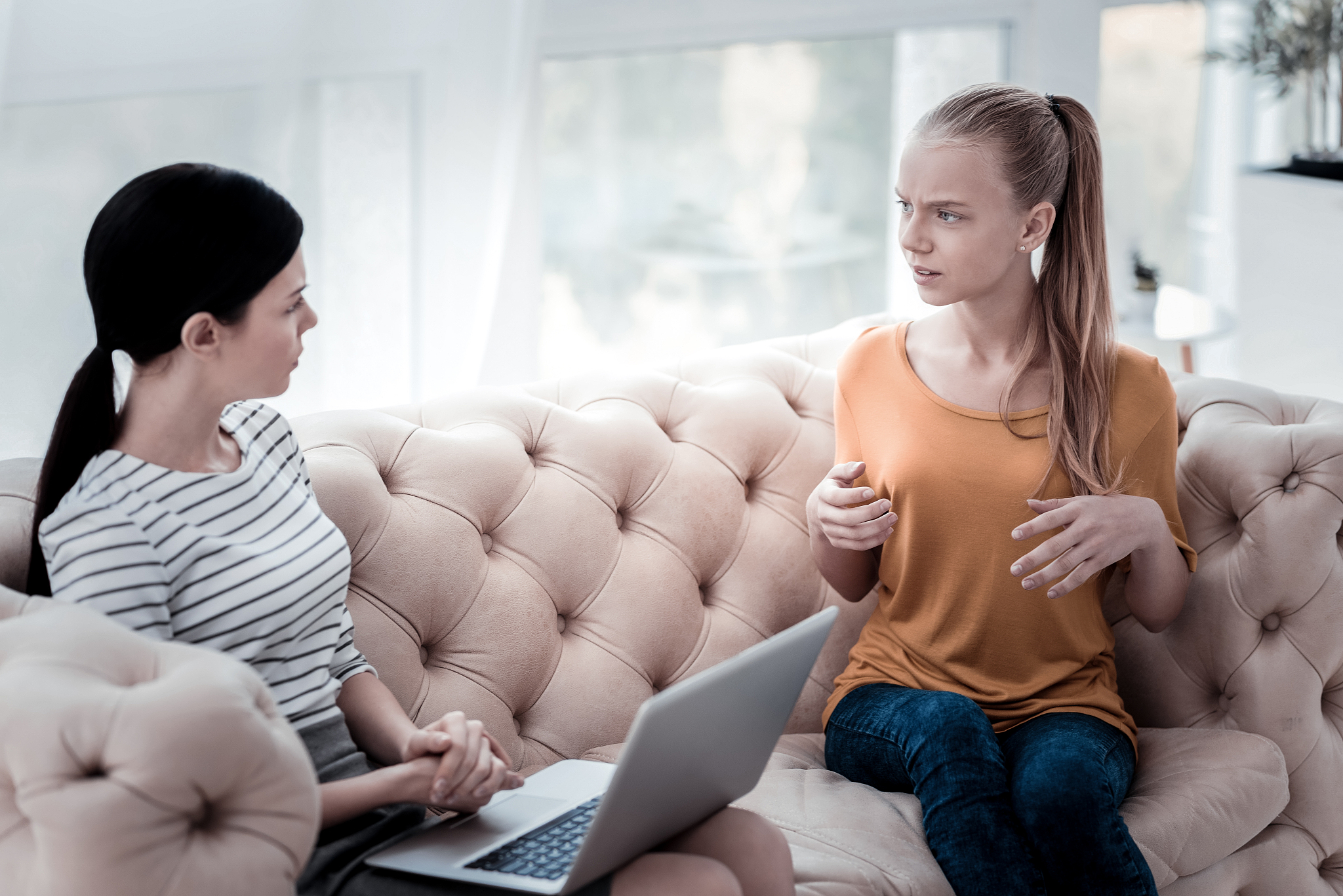 upset girl communicating with professional psychologist