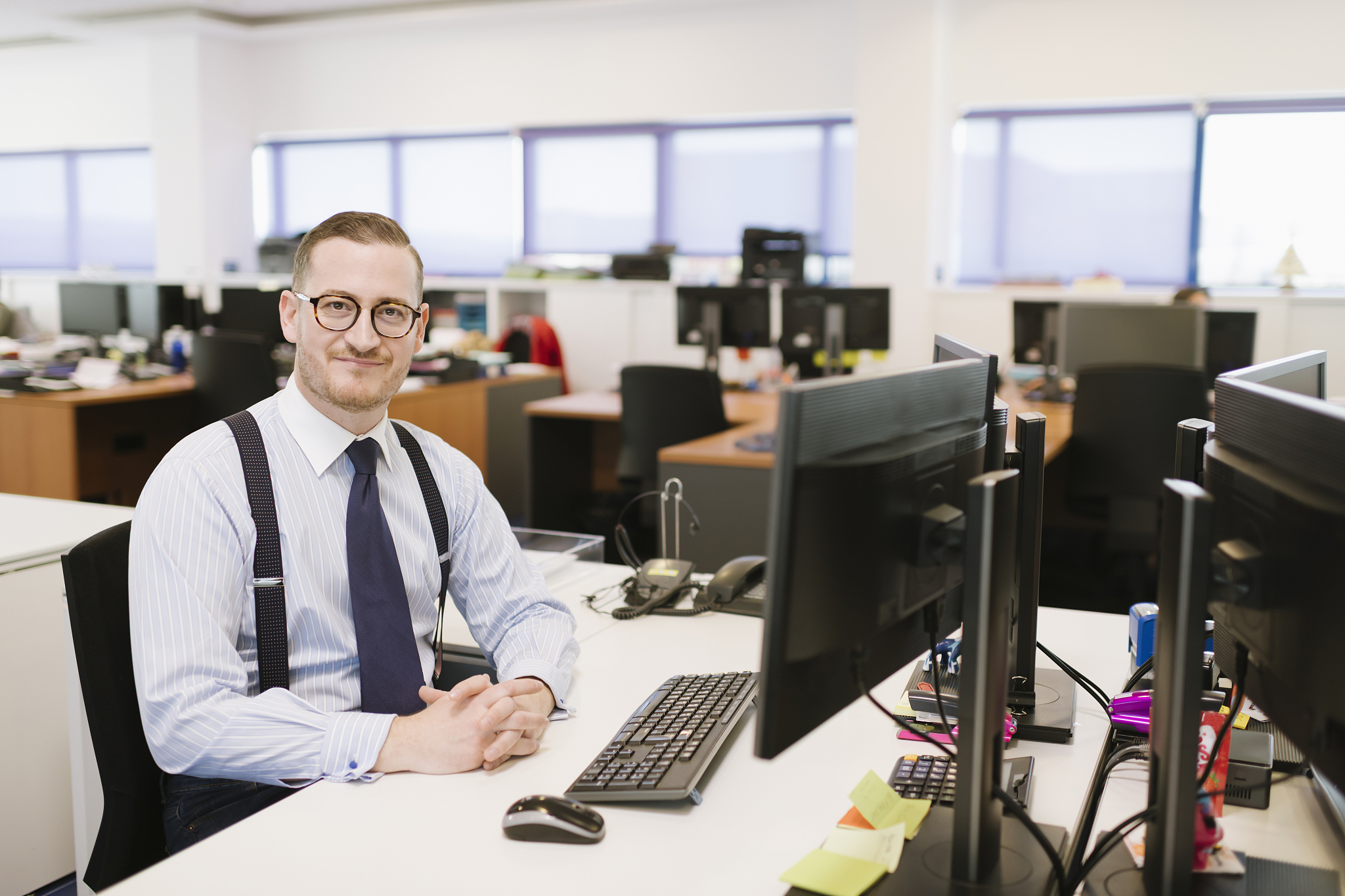 portrait of confident businessman at desk in office
