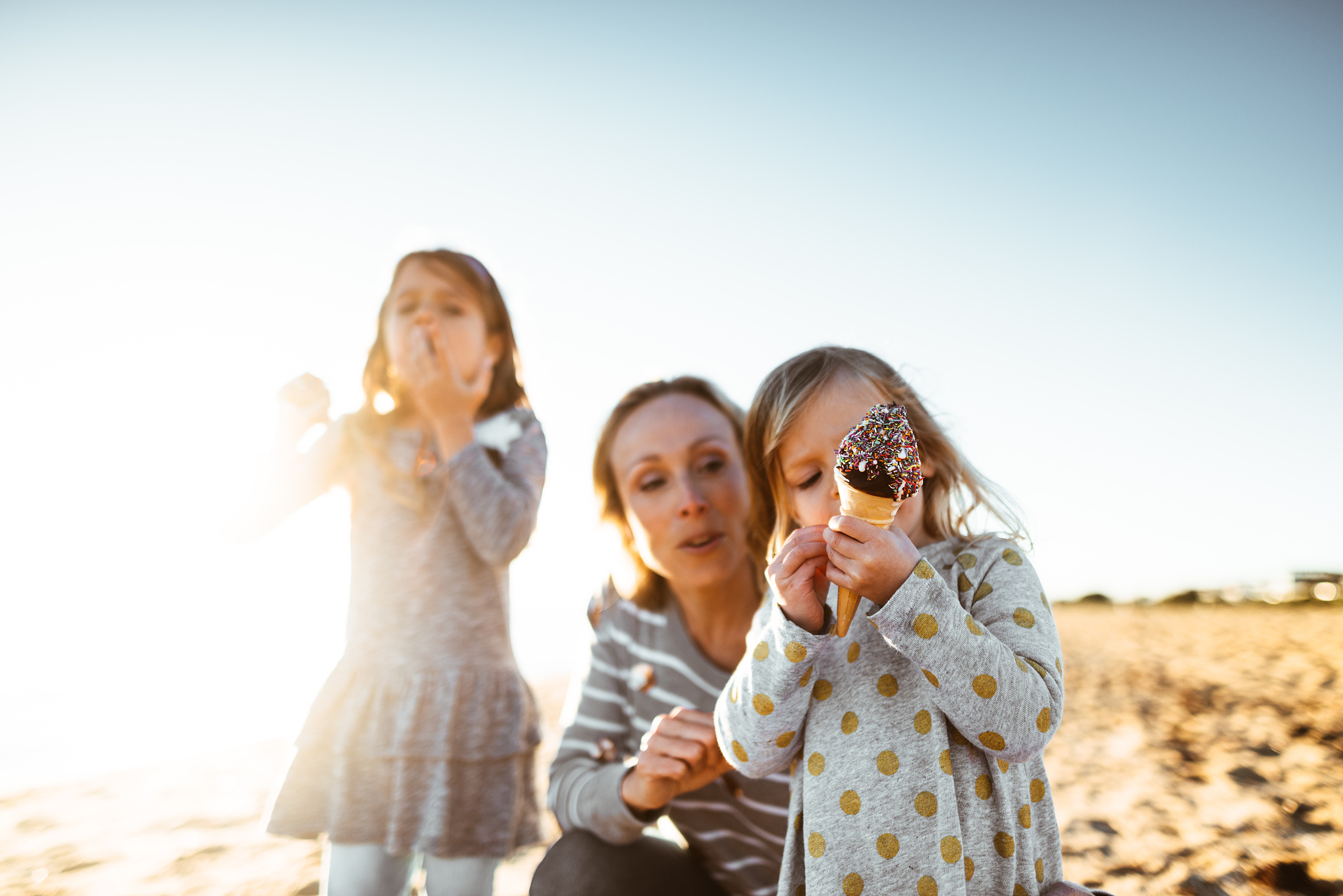 happy family eating the icecream on the beach