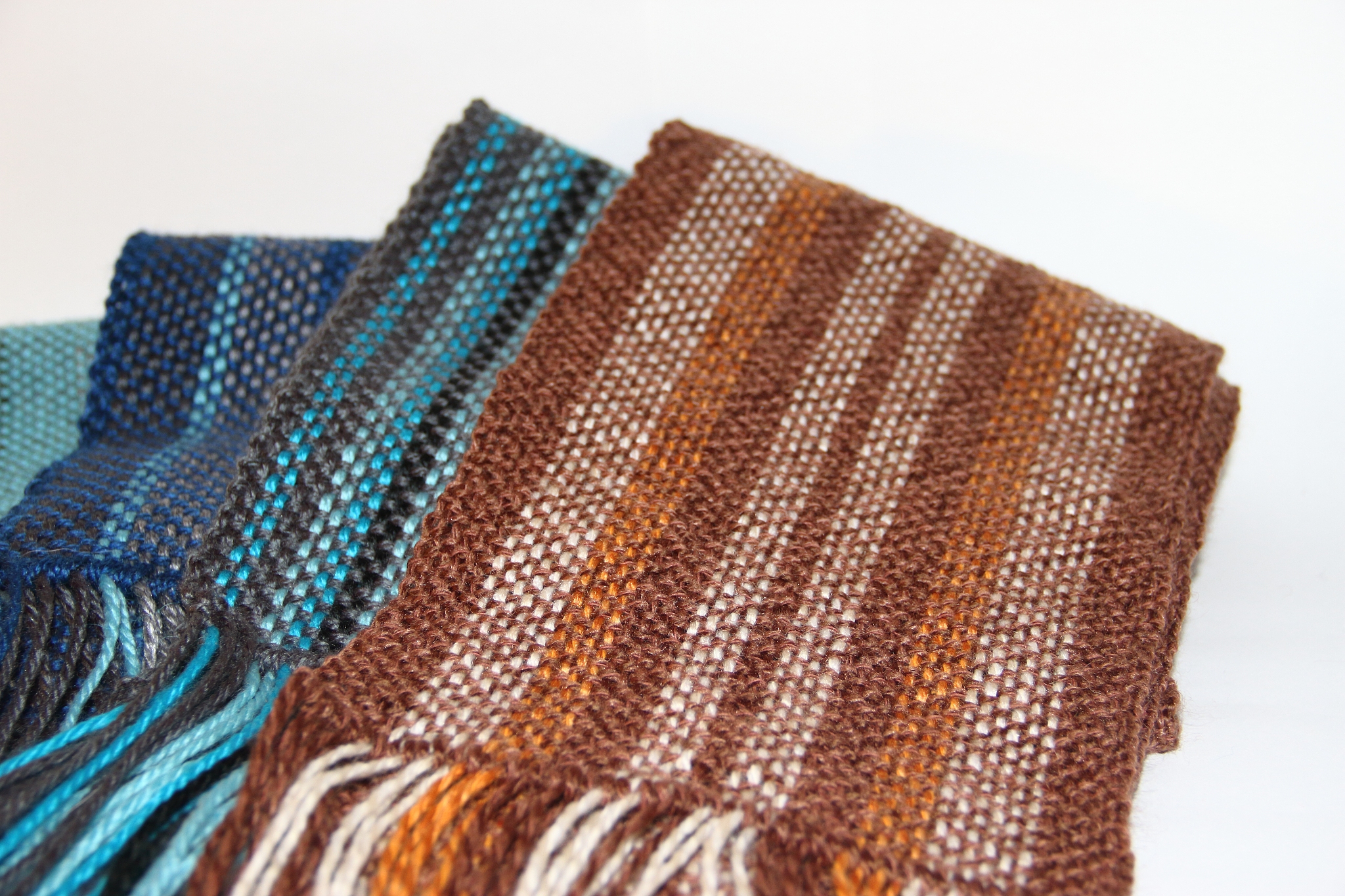 colorful knitted garments and blankets, comb loom, yarns