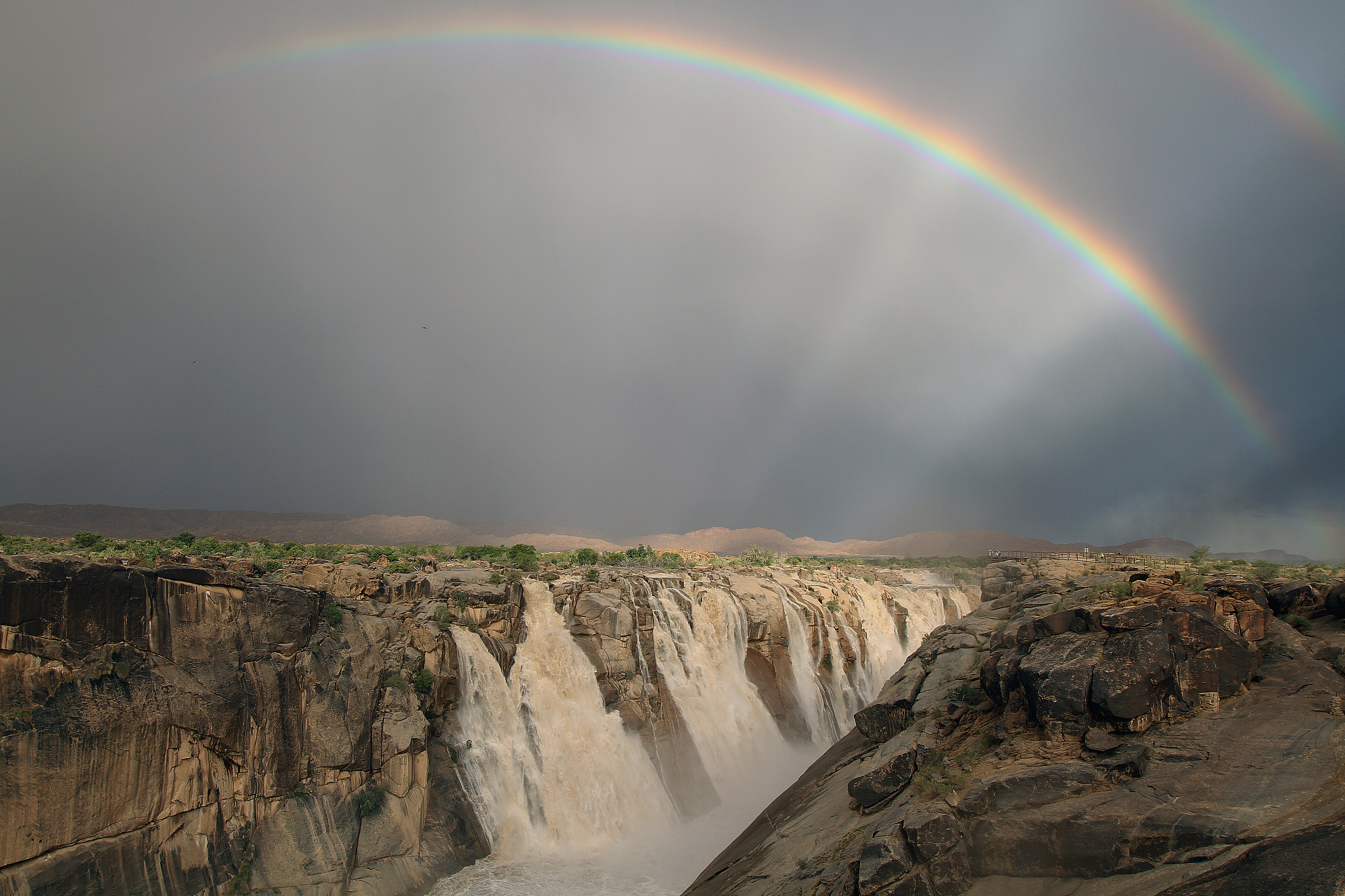 rainbow over augrabies falls, northern cape, south africa