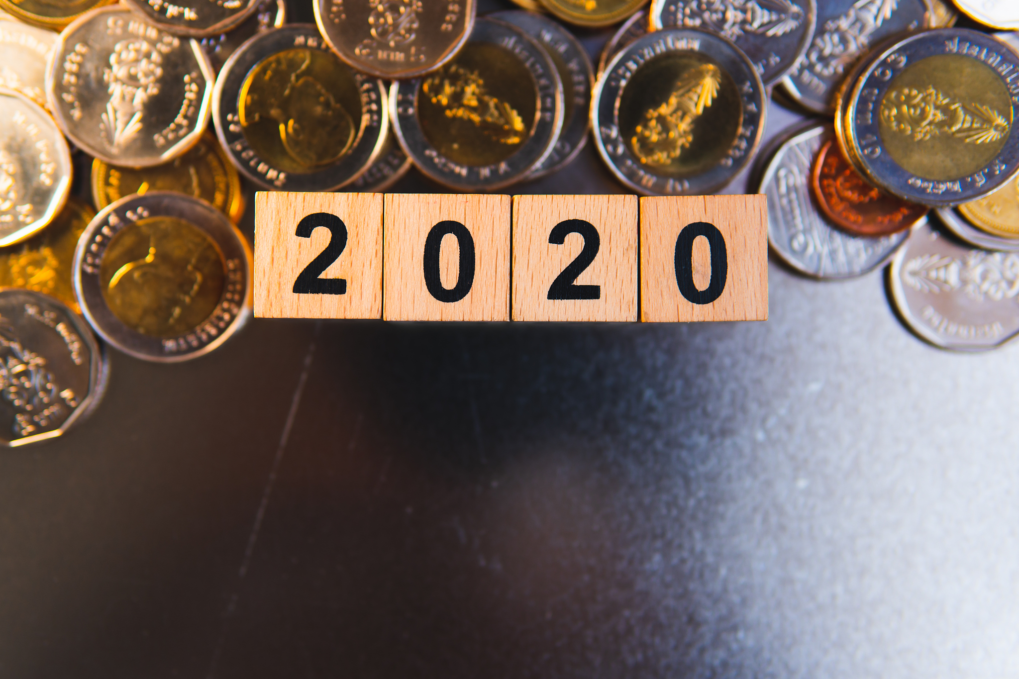 wooden block year 2020 with stack coins