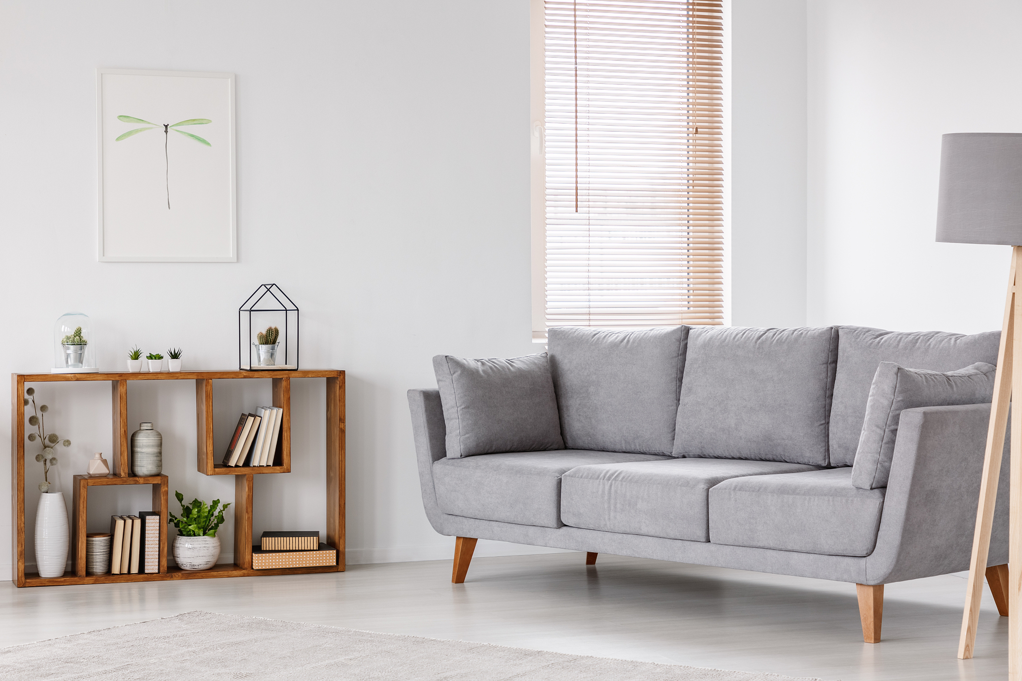 real photo of a scandi living room interior with gray settee sta