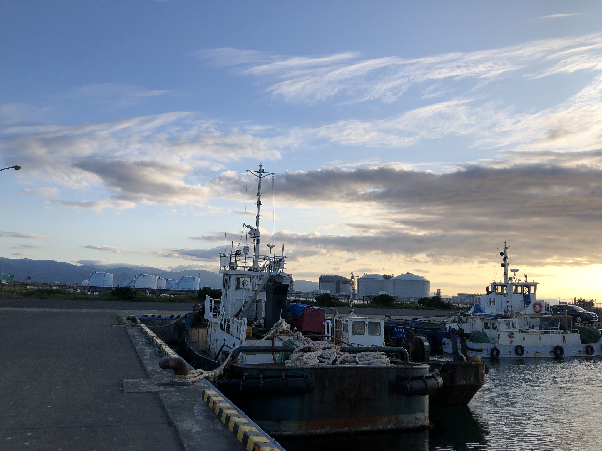 ship moored at harbor against sky during sunset