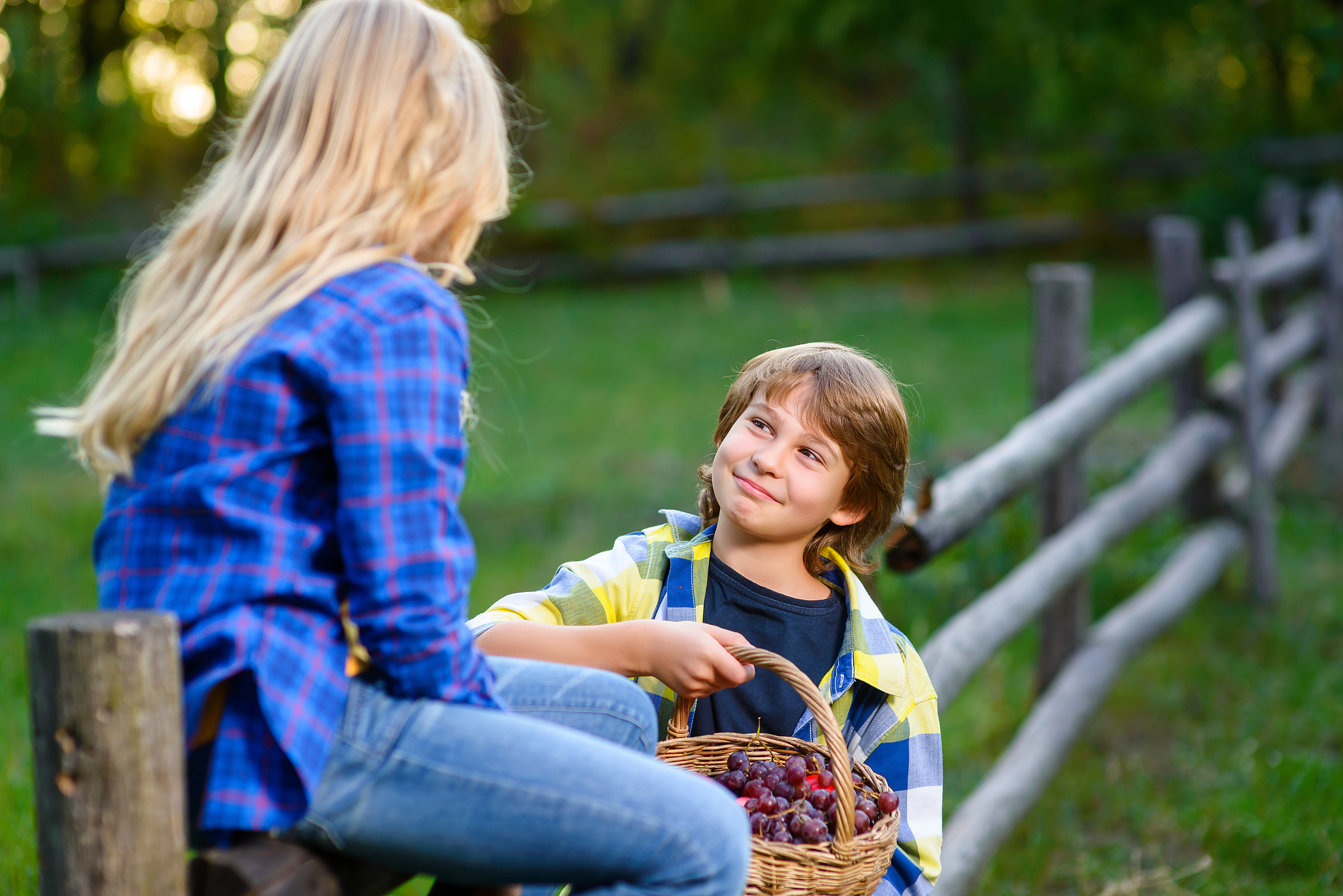 happy kids eating fruits from picnic basket outdoor. romantic or