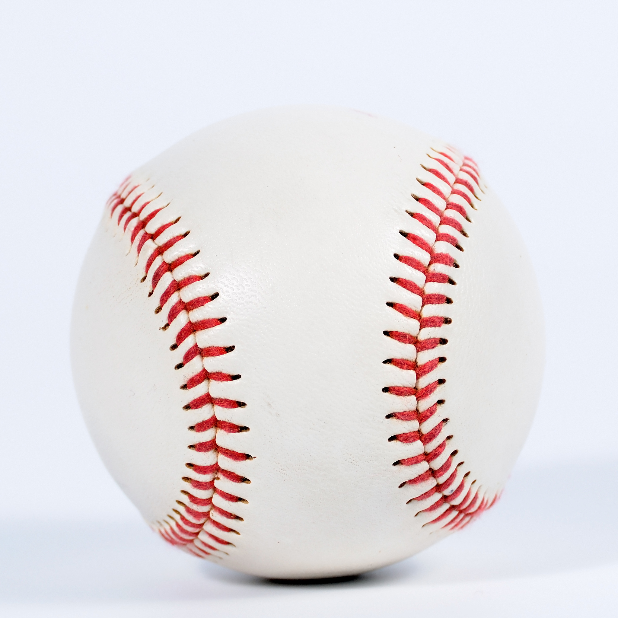 single baseball with red knit.