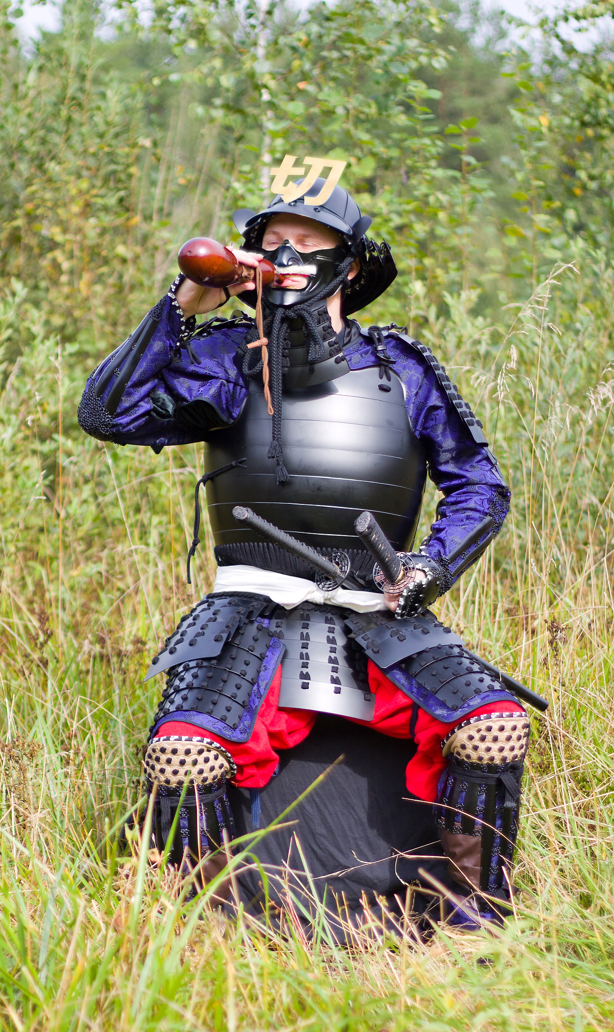 samurai in armor drinking from flask