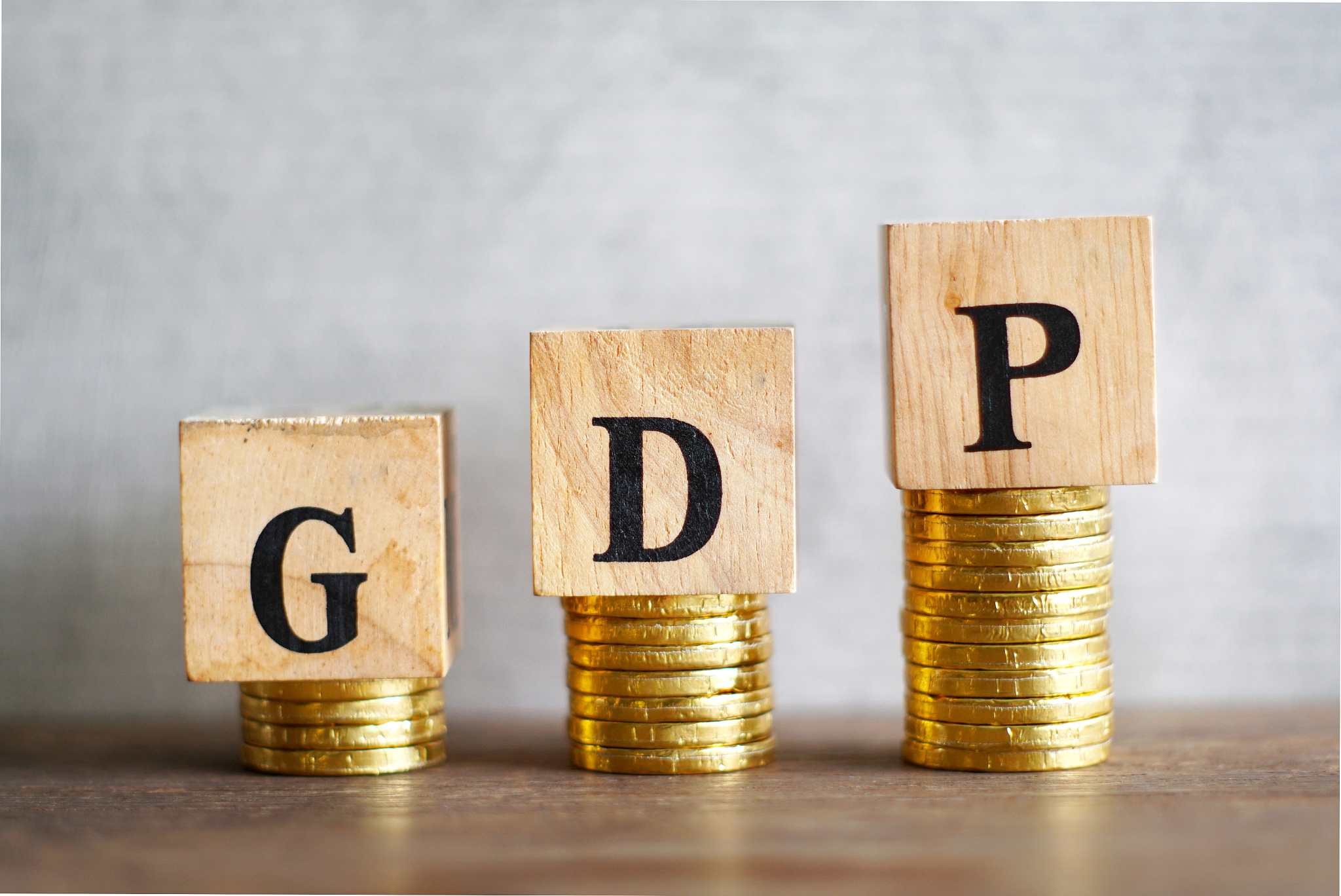 text "gdp" on wood cube decorate on growth coins stack, macroeco