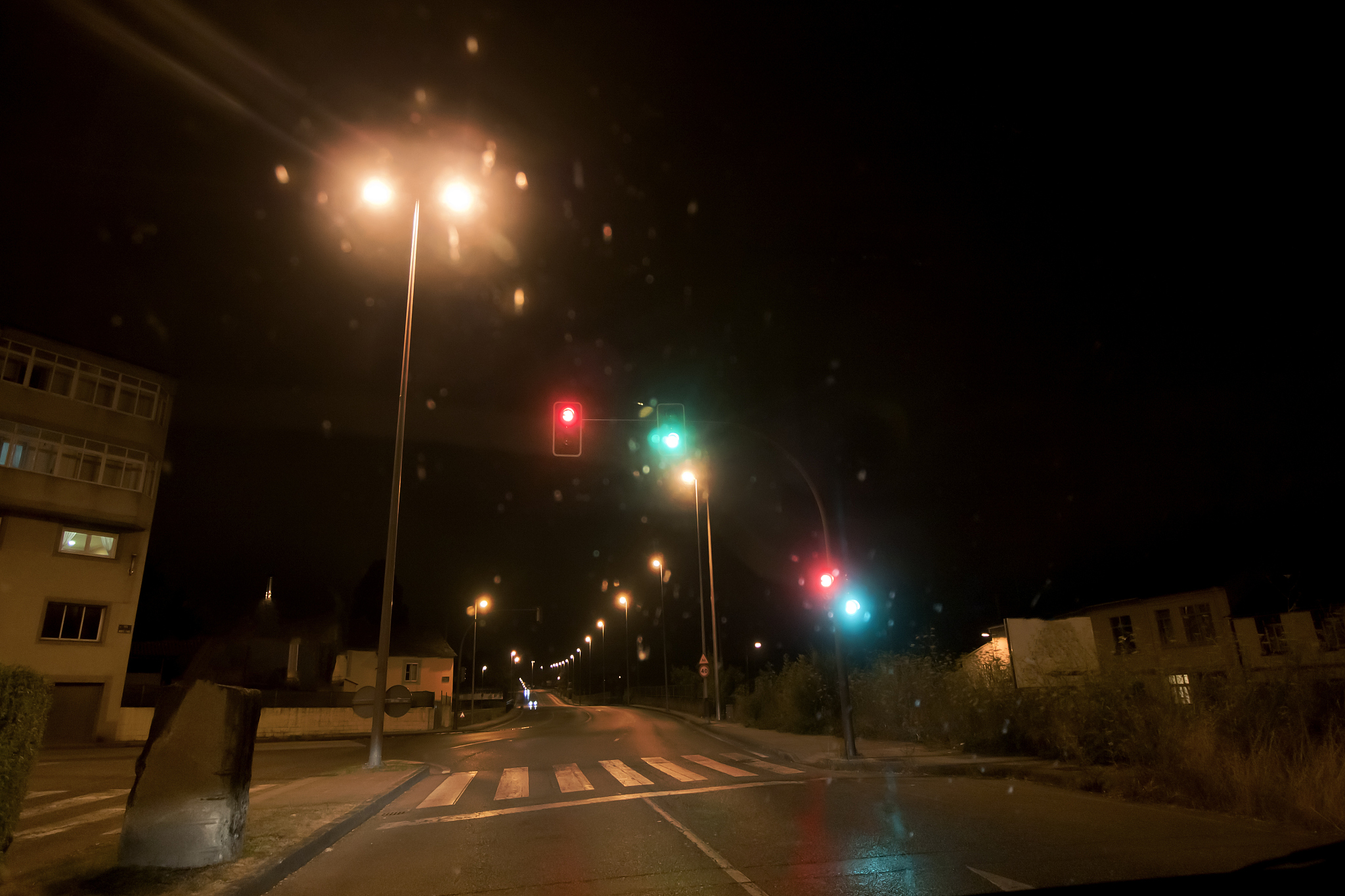 rainy night street view , traffic and street lights.