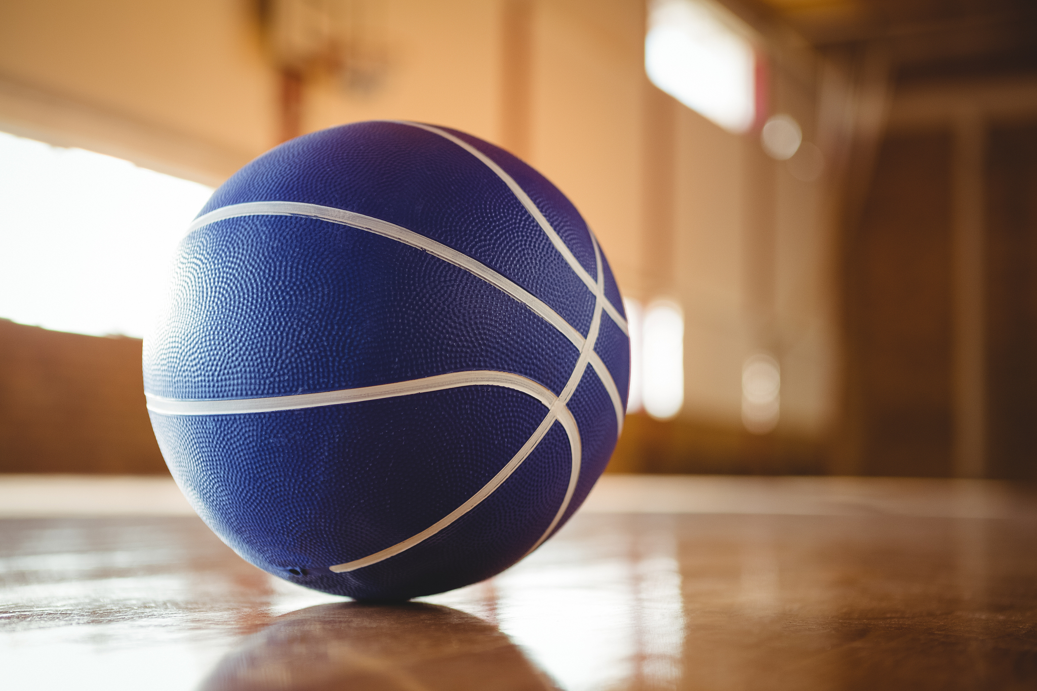 blue basketball on hardwood floor