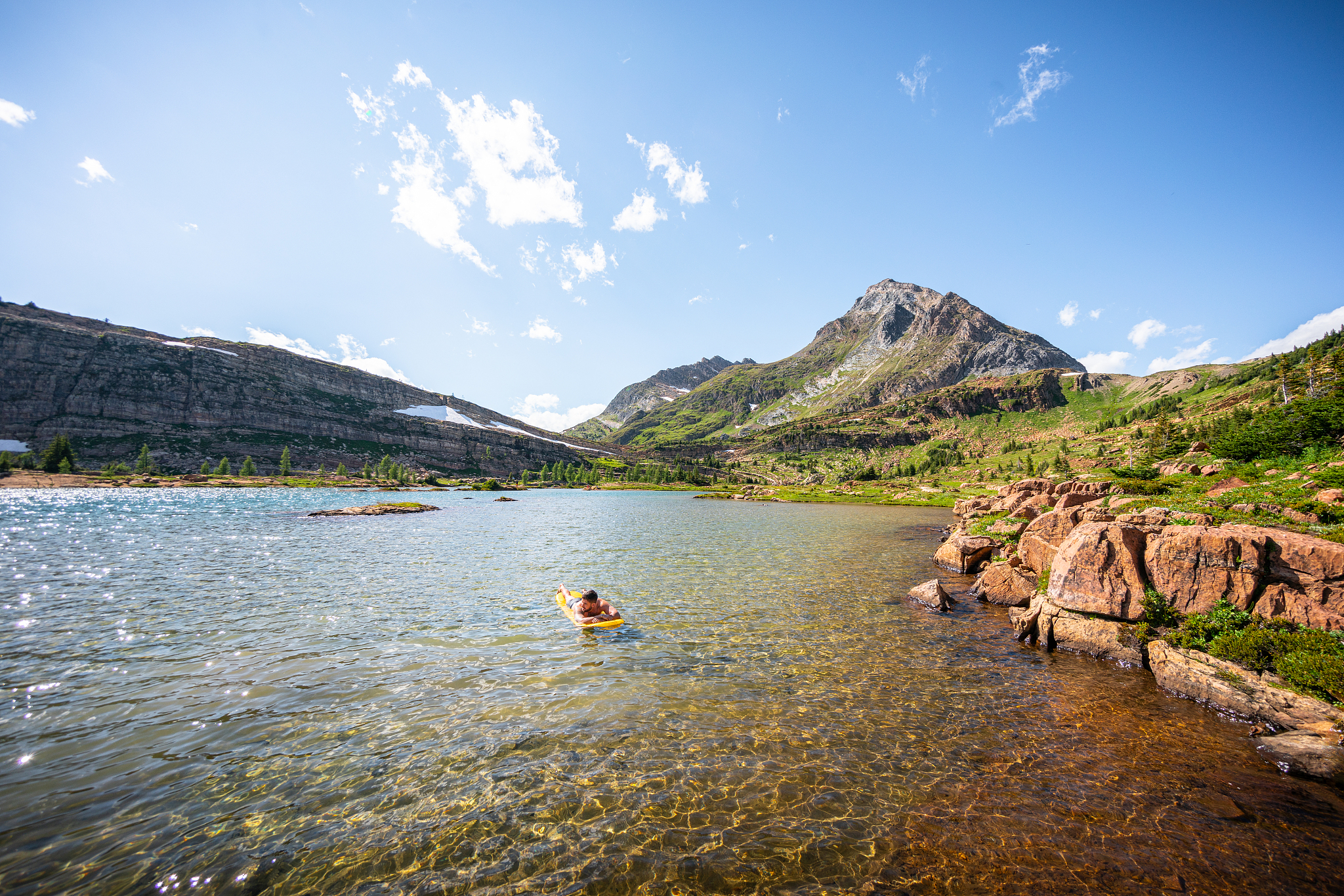 floating on a sleeping pad on alpine lake at limestone lakes