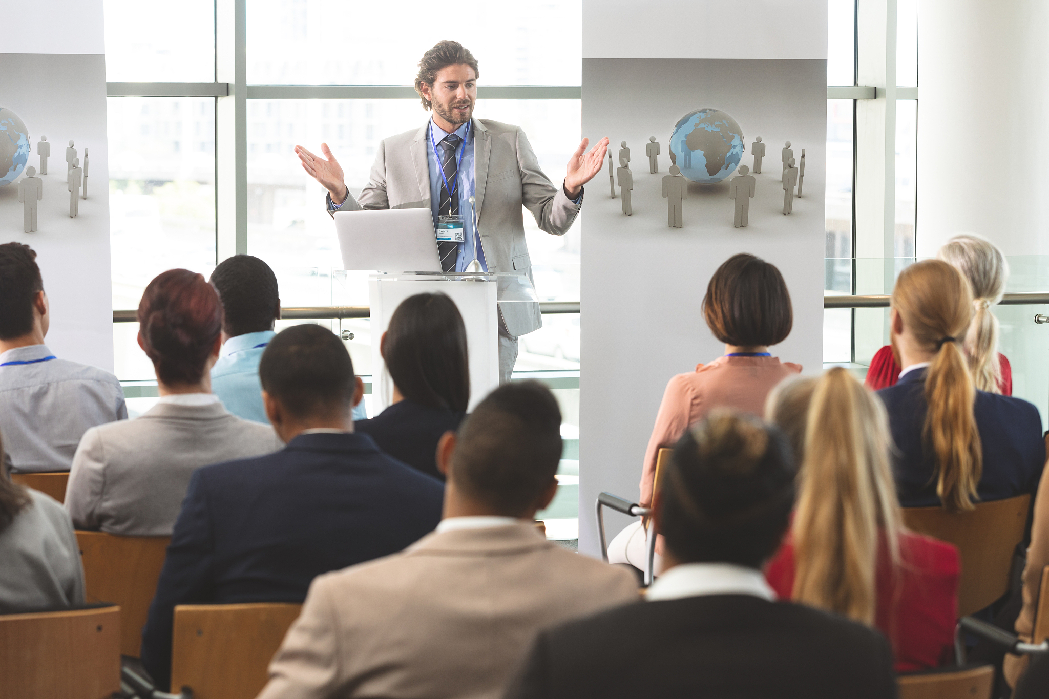 male speaker with laptop speaks in a business seminar