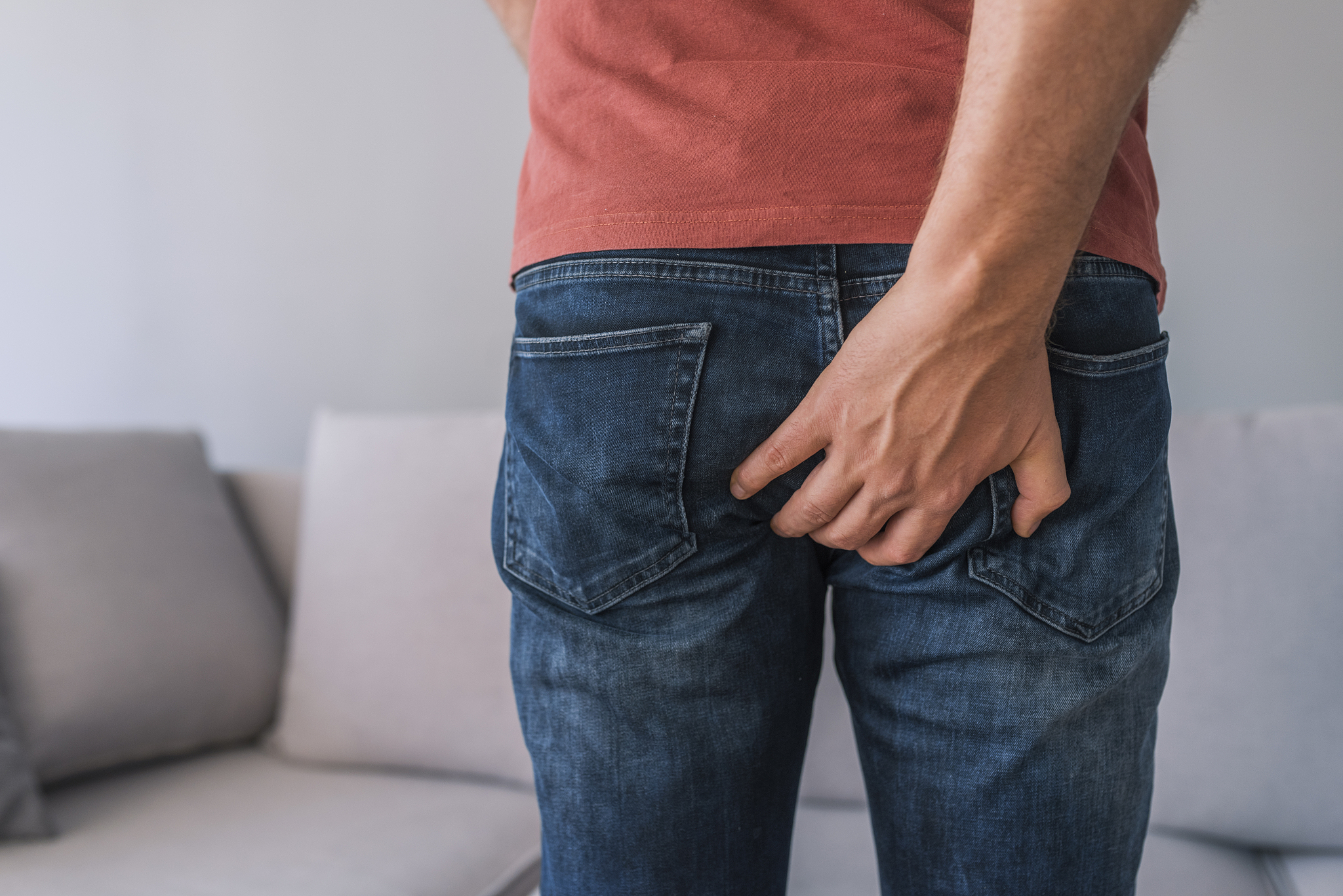 rear view of man scratching his backside