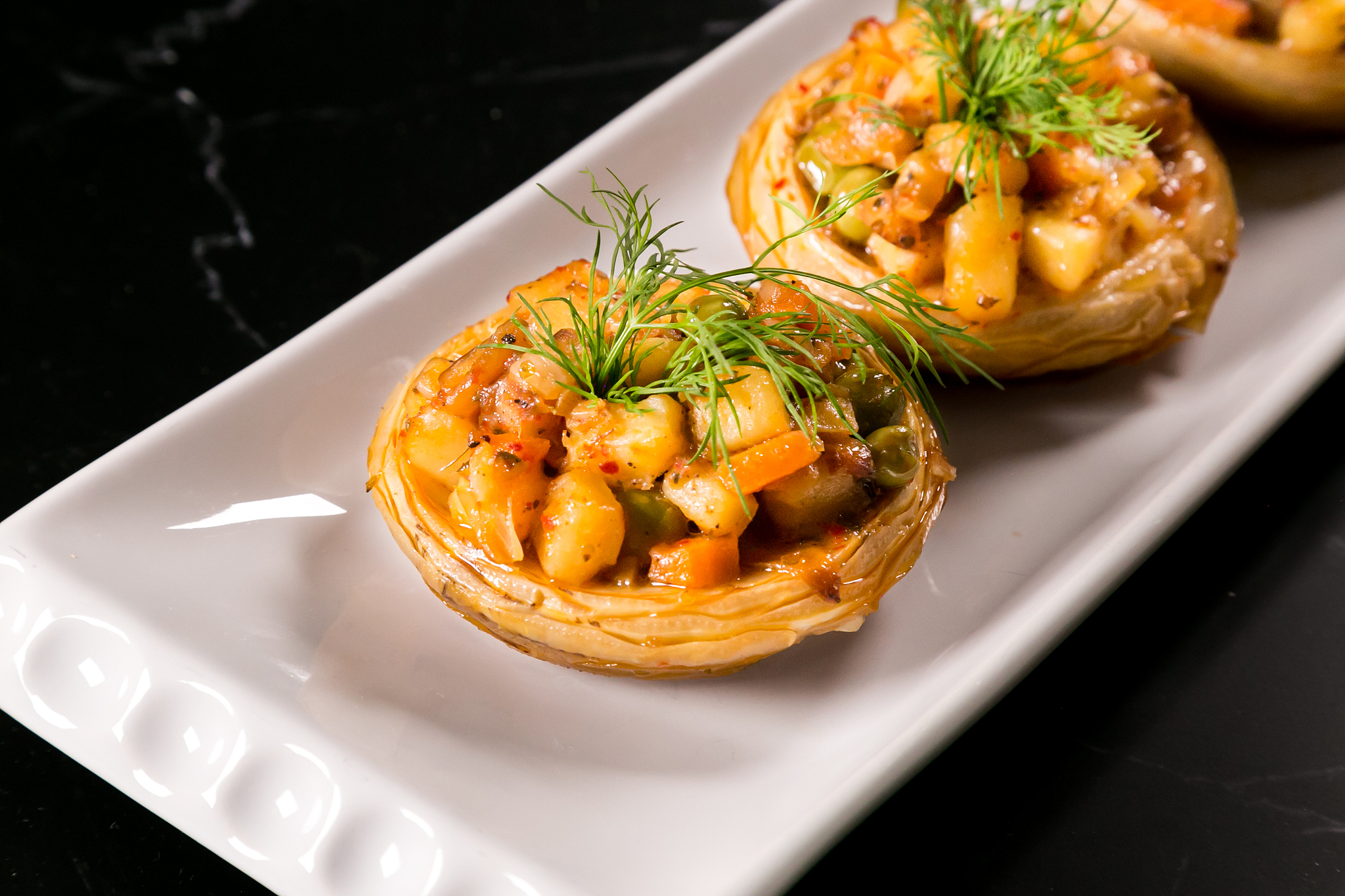 artichoke filled with vegetables on plate