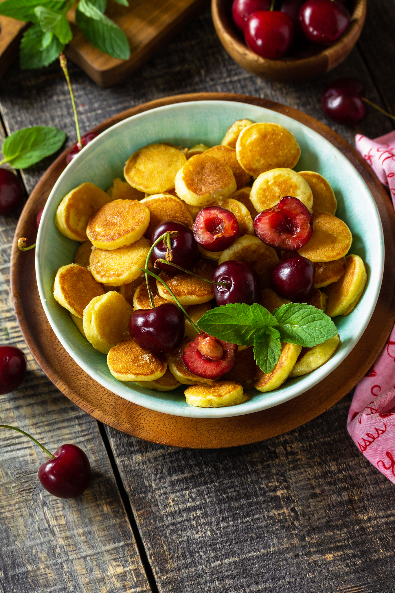 tiny pancakes trendy food. mini pancakes with cherries and honey