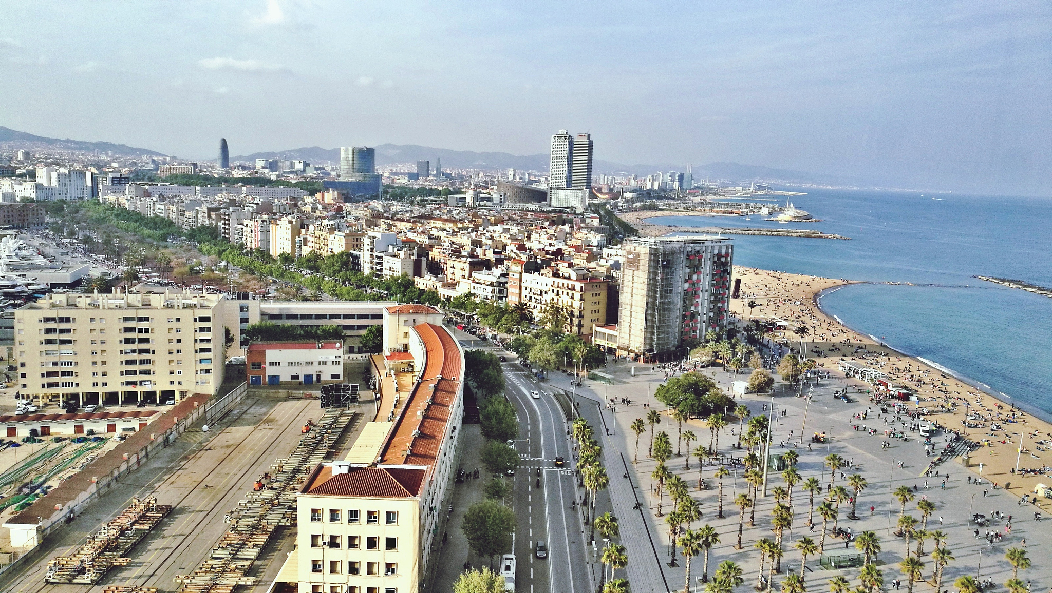 high angle view of buildings by sea against sky