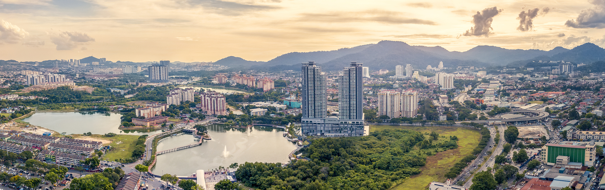 high angle view of buildings and trees against sky at sunset