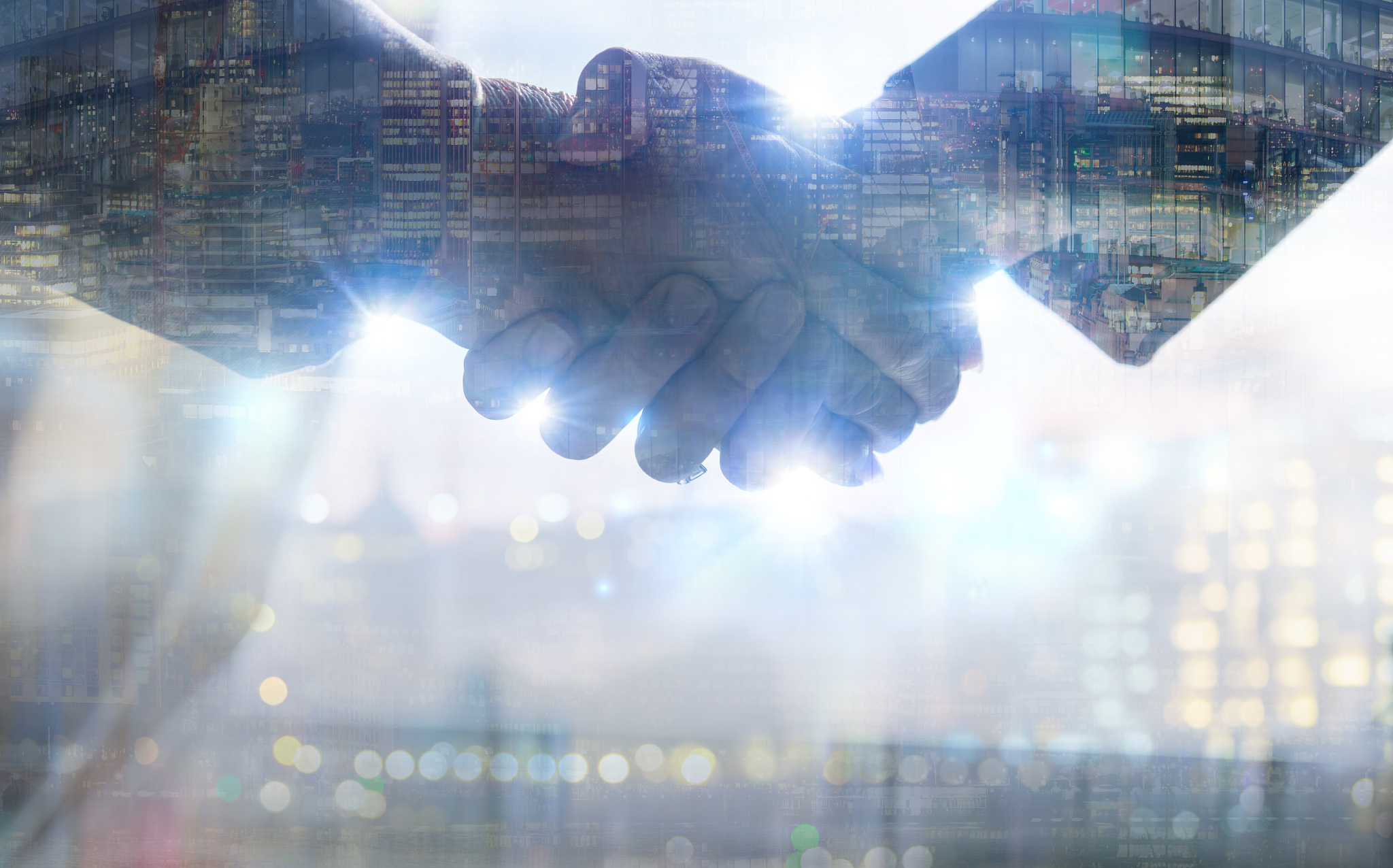 two business people shaking hands as symbol of agreement, consol